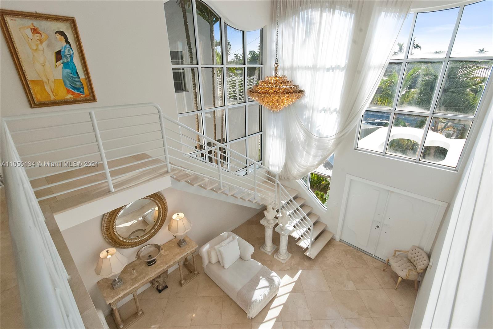 Stunning Bay Harbor Island two-story waterfront home designed by Kobi Karp featuring 75 feet of waterfront, 24-foot ceilings in the foyer, and an open floor plan with an abundance of natural light. Enjoy the beautiful water views from four custom wave balconies or while bathing in a relaxing tropical saltwater pool/Jacuzzi. Currently configured with four suites and five baths plus a cabana bathroom, study/office with wood library, staff room with separate entrance, wet bar, and a gym.