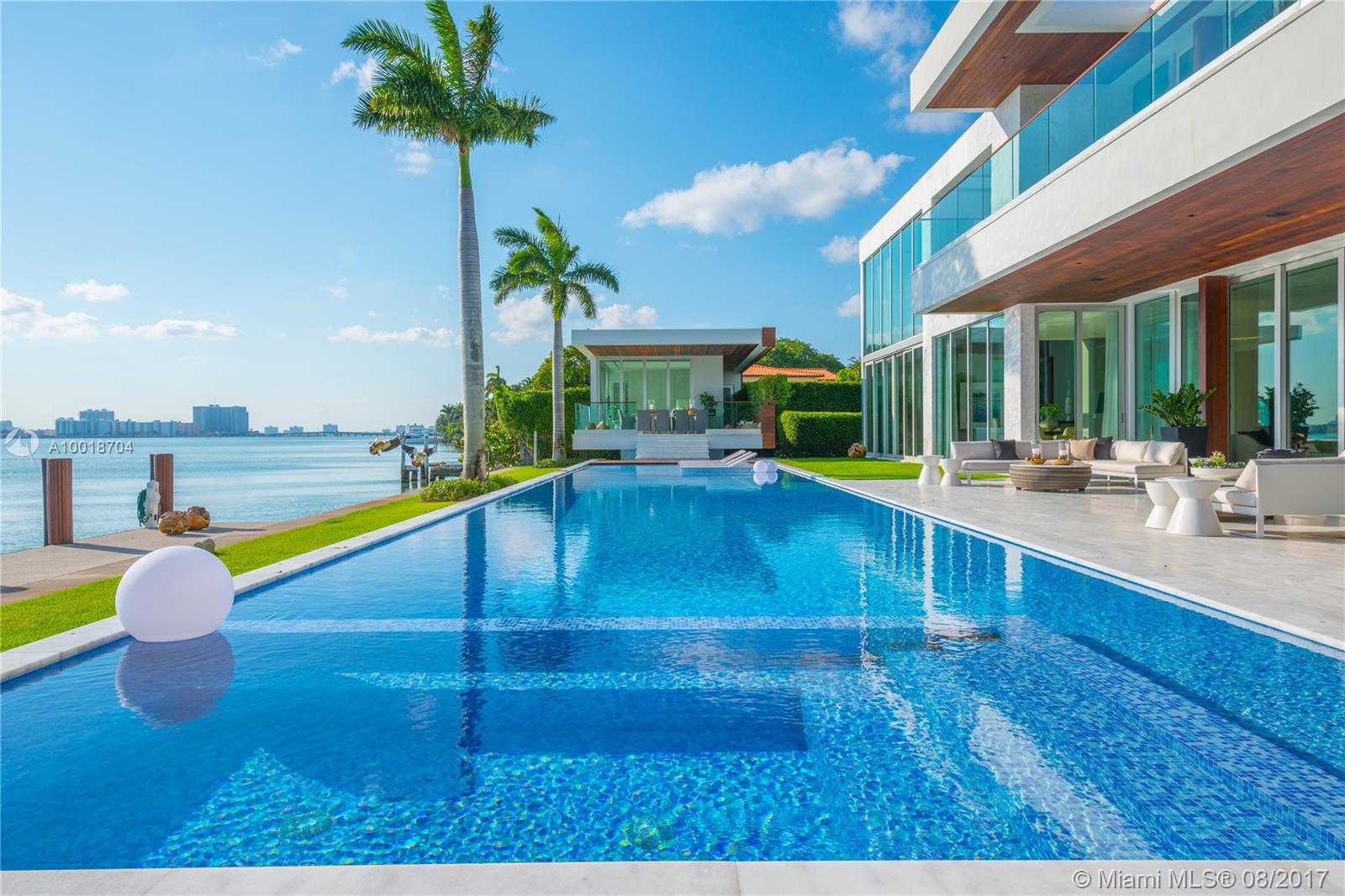 5446, is a true Jewel Box. Located on Prestigious N. Bay Road, lay an architectural masterpiece nothing short of Spectacular. This "smart home" includes a chefs kitchen, Otis elevator,floating curved staircase, rooftop terrace,gym,70" pool/spa, 3 koi ponds, and retractable doors that offer sweeping views of the Miami skyline. From Mega Developers Todd Michael Glaser and the Posner Group. Approved plans for large gym, theater, and 2 more staff rooms above garage adding 2,233 SF.