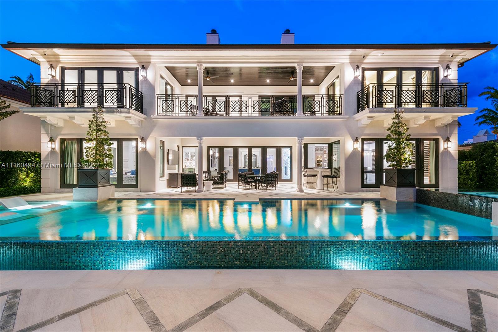 A custom, brand new one of a kind masterfully created waterfront mansion in the heart of Seven Isles, Ft. Lauderdale, the yacht capital of the world. No expenses spared in this timelessly designed home featuring a grand double height entryway, a thoughtful floorplan, oversized rooms, and a grand master chefs kitchen with double Nero Portoro marble islands with rare gold lining. Amenities include a quartzite bar rivaling your best local commercial bar, a movie theatre fit for royalty, a snow marble backyard and 90 ft boat dock, and a breathtaking infinity tiled pool and jacuzzi making this oasis complete. The principle quarters open up by double doors spanning the whole width of the home to a private foyer with a warm large bedroom, and two massive walk in closets. Offered turnkey furnished
