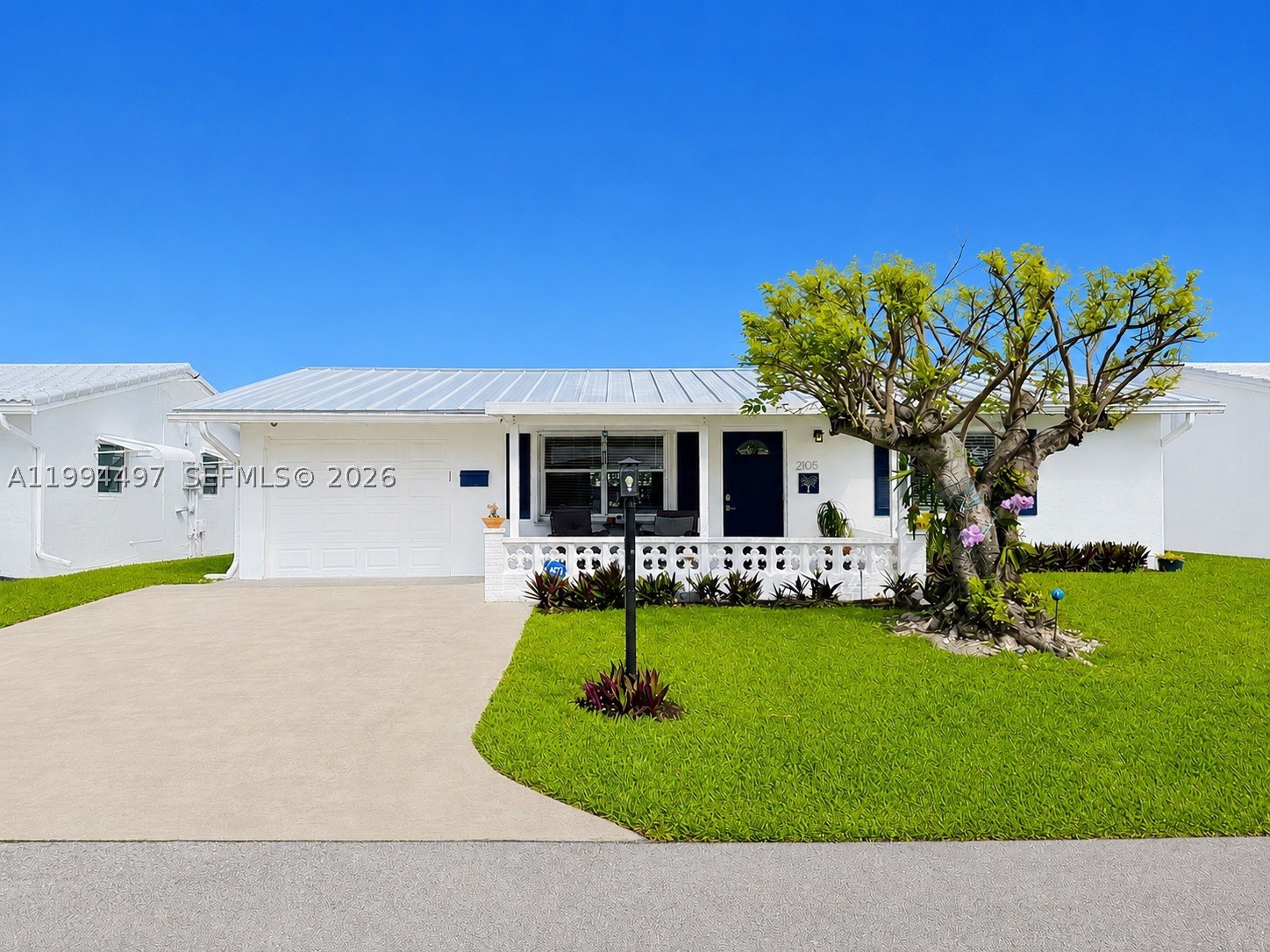 NEW 2025 METAL ROOF | MOVE-IN READY | LOW HOA In today’s market, homes with major updates already completed offer real value, and this one delivers. Located on sought after SW Park Drive in Palm Beach Leisureville, this beautifully updated 2 bedroom, 2 bath home features a brand new 2025 metal roof, fully remodeled bathroom, updated office with new flooring ideal as a den, guest room, or potential third bedroom, 2018 Rheem A/C, 2017 water heater, and full accordion shutters. The bright and open layout includes an updated kitchen with granite countertops, expansive breakfast bar seating, matching appliances, and seamless flow into the main living and Florida room areas. Natural light brightens the home throughout, while the enclosed Florida room adds valuable extended living space for relaxing or entertaining. Enjoy a low HOA that includes lawn care, three clubhouses, heated pools, fitness centers, social activities, and complimentary golf. Conveniently located near beaches, shopping, dining, and medical facilities, this move in ready home offers the updates, lifestyle, and peace of mind today’s buyers are looking for. Schedule your private showing today!