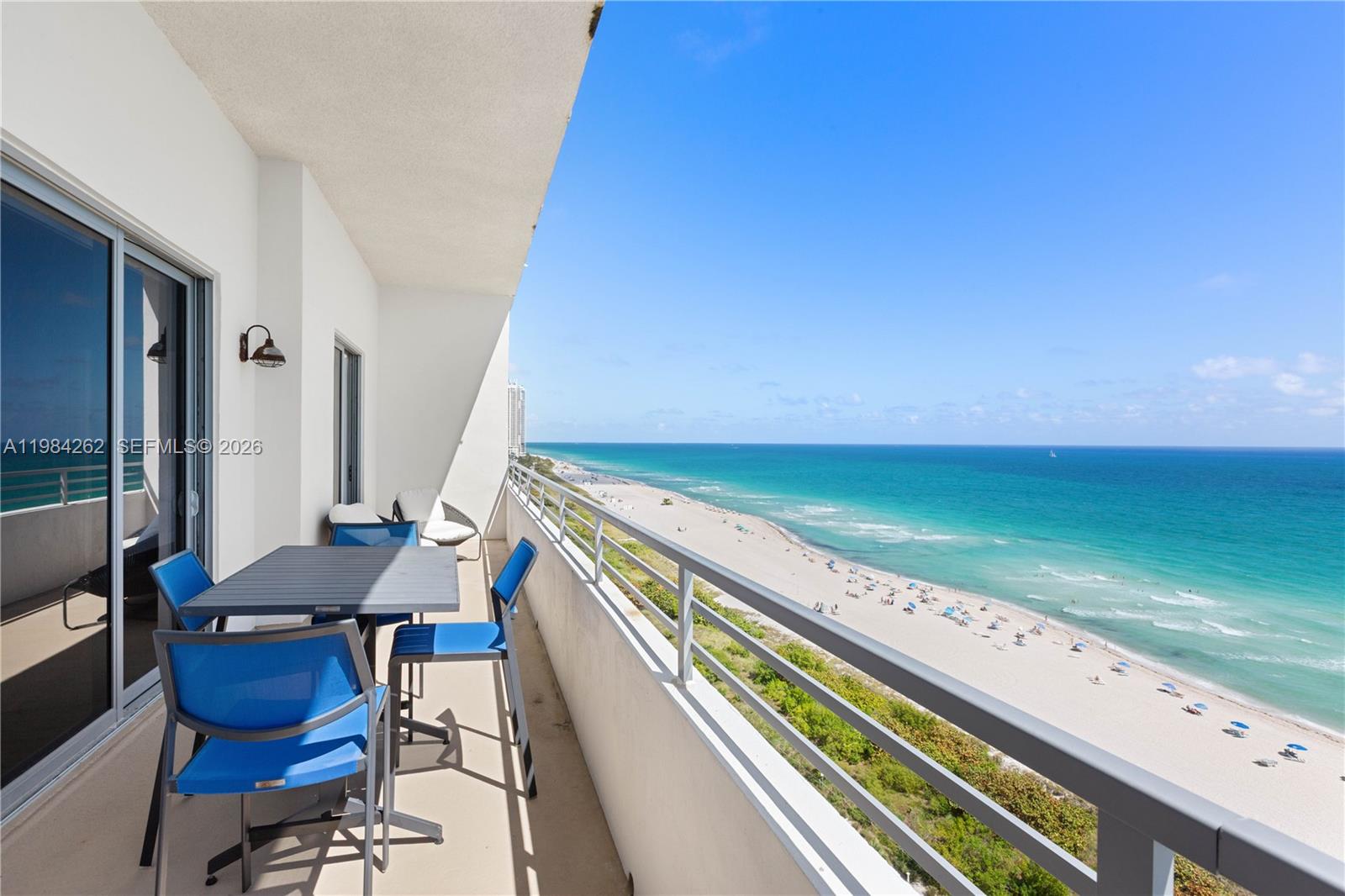 Perched in the iconic 5555 Collins, this stunning oceanfront residence captures perfectly centered, unobstructed views that stretch endlessly across the horizon, filling the home with natural light from sunrise to sunset. Designed with both style and versatility in mind, the layout features 1 bedroom and 2 full baths, along with a flexible Murphy bed area that can be enclosed with a sliding door—creating a comfortable second sleeping space ideal for guests.
The interior showcases a bright coastal aesthetic with crisp white finishes, complemented by subtle exposed concrete accents that introduce a modern architectural edge while maintaining a warm, inviting feel. High ceilings and a thoughtfully designed open-concept layout enhance the sense of space, allowing the breathtaking ocean views to remain the focal point from multiple vantage points throughout the home.
Seamless indoor-outdoor living is achieved through three sets of sliding glass doors that lead to an expansive, full-length balcony spanning the entire unit—perfect for dining al fresco, relaxing, or enjoying the ocean breeze. With its clean, minimalist design and a floor plan oriented to maximize light and views, this residence offers a truly elevated beachfront living experience.