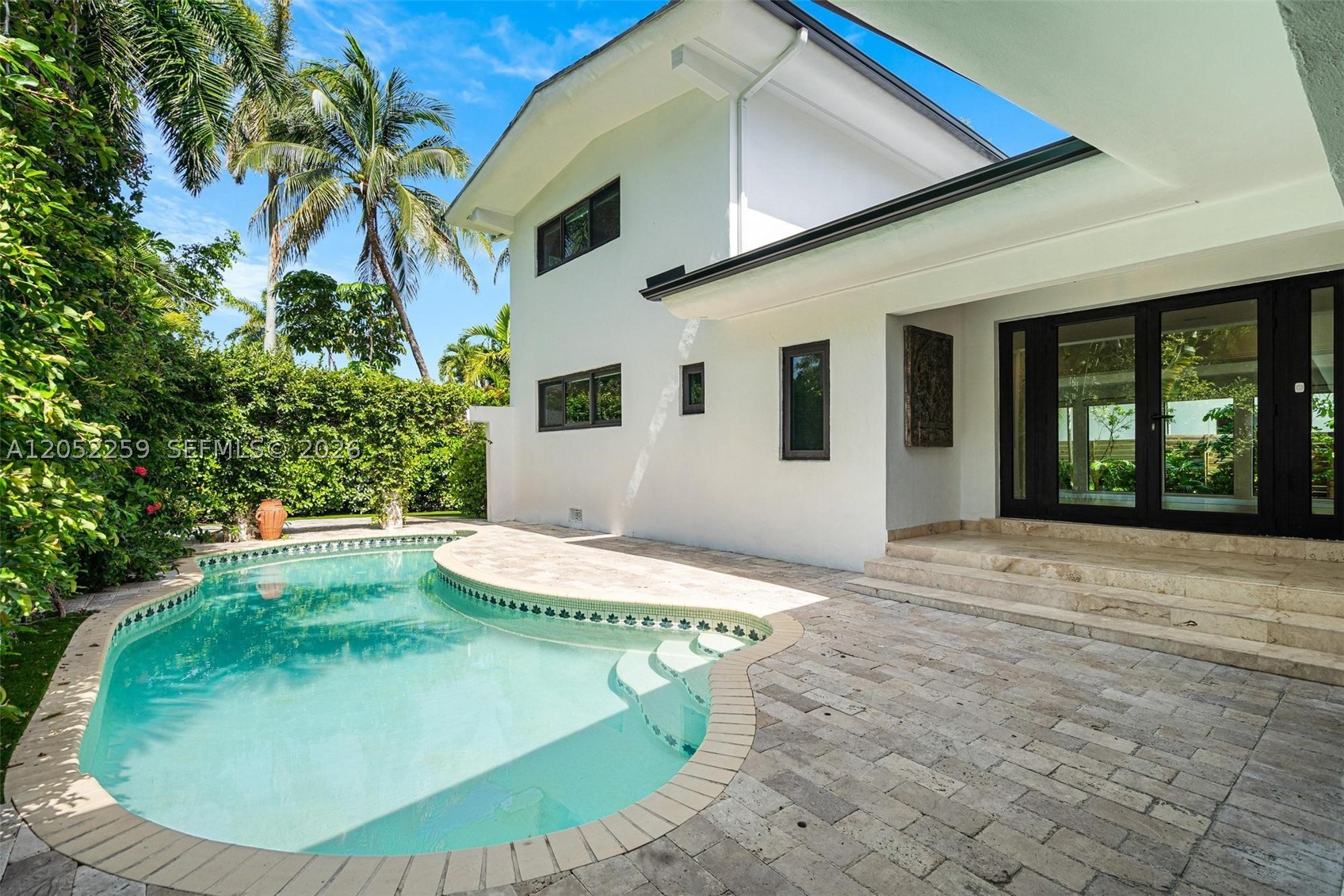 Nestled in the gated, quiet community of North Bay Island in Miami-Dade, recently renovated home offers something increasingly difficult to find: generous living spaces and a practical floor plan. Enter through the covered patio next to the pool to enjoy the outdoors. Whether starting with a breakfast outside, hosting friends, or simply escaping the afternoon sun, this is a space that can be used year-round. The extra-large living and dining areas offer many options for entertaining or creating spaces for everyone in the family. The house is filled with natural light and greenery all around. Two bedrooms downstairs share a bathroom, while upstairs the primary suite enjoys its own level. It is designed as two separate areas: the bedroom on one side and a sitting room or office on the other, creating a comfortable retreat that can easily adapt to different needs. A separate guest wing provides additional privacy and can serve as guest accommodation, an in-law suite, staff quarters, or a dedicated workspace. 
North Bay Island is one of those neighborhoods that many people discover by chance and never want to leave. Surrounded by Biscayne Bay, the island offers a quiet residential atmosphere with gated security while remaining just minutes from Miami Beach, Bal Harbour, Design District. Miami Country Day School and several excellent schools nearby. Available immediately for yearly rental, renewable, unfurnished (some pictures are virtually staged).