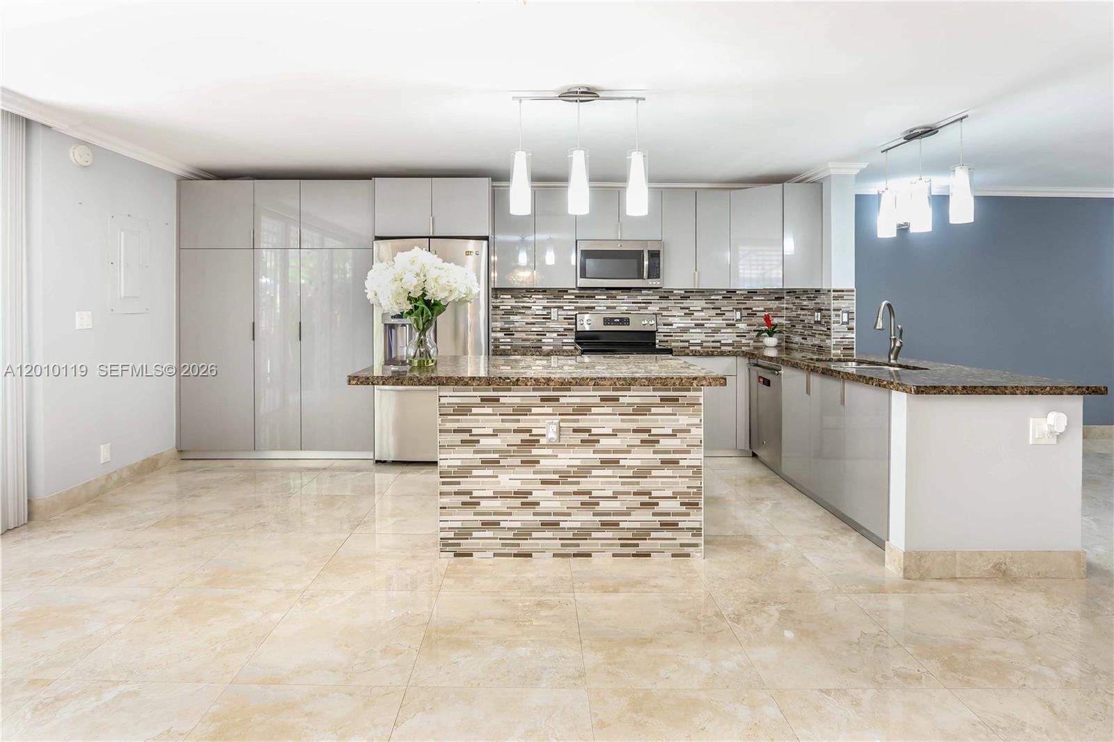 Beautiful 2-bedroom, 2.5-bath residence offering the perfect blend of comfort, style, and functionality in a prime location just a short walk to the beach.

Both spacious bedrooms are located on the second floor and feature bamboo flooring, large closets, and private ensuite bathrooms. Each bath has been tastefully renovated with floor-to-ceiling porcelain tile and elegant mosaic accents. One suite includes a shower/tub combination for added versatility. A full-size washer and dryer are conveniently located upstairs.

The main level is designed for both everyday living and entertaining, featuring porcelain tile flooring, crown molding, and a warm wooden staircase with additional storage underneath. Enjoy multiple living spaces including a formal dining room, family room, and inviting living area.

The open-concept kitchen is a standout, complete with granite countertops, mosaic backsplash, a center island, and abundant cabinetry—ideal for hosting and gathering.

Step outside to your own private backyard oasis with a jacuzzi and storage shed, perfect for relaxing or entertaining guests.

This well-maintained community offers resort-style amenities including two tennis courts, a heated pool, clubhouse, fitness center, and a party room with full kitchen. All of this in close proximity to airports, cruise ports, area hospitals, shopping, dining, and entertainment!

Includes two assigned parking spaces.