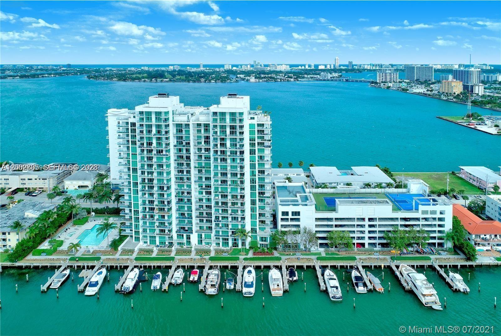 Elegantly appointed 1,400 sq. ft. condominium in the prestigious North Bay Village enclave, ideally located just minutes from Miami Beach, Midtown, Downtown, and North Miami. This residence features soaring ceilings and breathtaking panoramic vistas, capturing the westward shimmer of the water against the Miami skyline and the expansive eastern horizon. The spacious master suite is a true sanctuary, complete with an expansive walk-in closet, luxurious ensuite bath, and direct balcony access. The secondary bedroom, designed in a suite-style layout, also enjoys its own east-facing balcony. A generous den offers versatile use as a cozy third bedroom or home office. The unit includes two dedicated parking spaces.