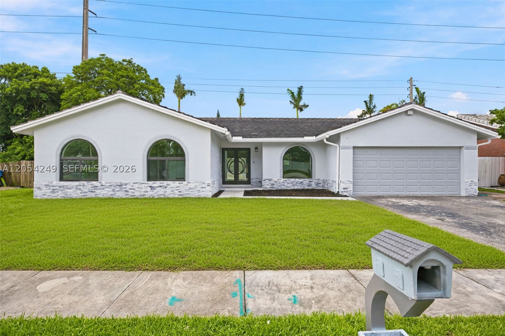 Virtually Staged. Beautifully remodeled 4-bedroom, 2-bath home with the flexibility to function as a 5-bedroom, 3-bath residence. A separate private suite with its own private entrance, bathroom, and kitchenette provides added versatility for guests, extended family, a home office, or additional living space. Located in a desirable South Miami area with no HOA, this home showcases modern finishes and thoughtful upgrades throughout. The double entry doors, large arched windows, and fresh exterior paint create an impressive first impression. Inside, enjoy 24x40 tile flooring, new 6-inch baseboards, fresh interior paint, impact windows, a newer roof (2021), and newer A/C (2019). The spacious layout features separate formal living and dining rooms, plus a bright family room overlooking the updated kitchen. French doors open to the outdoor living area, where you'll find a 20x30 pool, covered patio, fully fenced backyard, and RV hookup, creating an ideal space for entertaining and enjoying the South Florida lifestyle. The primary suite includes a large walk-in closet and direct access to the pool area. Conveniently located near shopping, restaurants, parks, Zoo Miami, and major roadways.