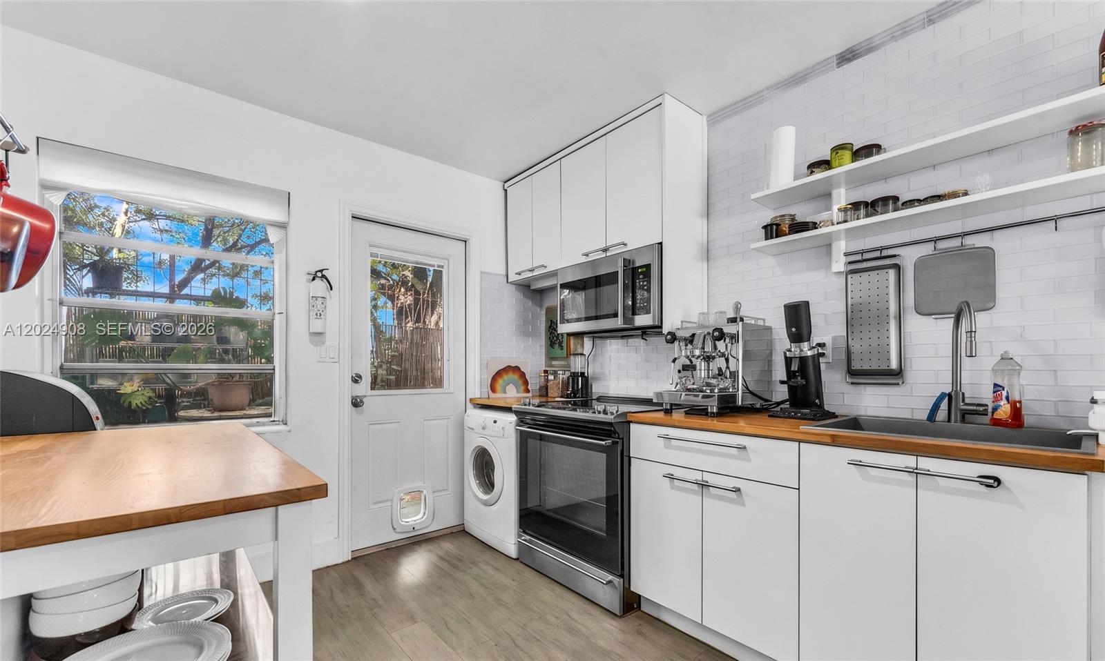 Welcome to your turn-key coastal retreat at 645 NE 77th Street, Apartment 1 in Miami. This substantially renovated ground-floor corner unit features two bedrooms, one bathroom, a DEEDED DOCK, and assigned parking, offering the ultimate South Florida lifestyle. The true highlight of this property is the rare deeded dock located just steps from your back door, fully equipped with water and electric. Perfectly suited for boating enthusiasts, the unit's deeded 33 ft dock provides direct ocean access with no fixed bridges, putting you on the open waters of the Intracoastal in five minutes or less. Inside, the home is filled with natural light and thoughtfully updated with clean, modern finishes, including a beautifully appointed kitchen, spa-like bathrooms, and seamless flooring throughout the open living space. Outside, you can enjoy a private, customizable backyard garden area that serves as a blank canvas for your own personal oasis, or spend the afternoon relaxing by the lush community pool situated directly on the waterway. This is an exceptional opportunity to own a move-in ready waterfront home with premier boating access.