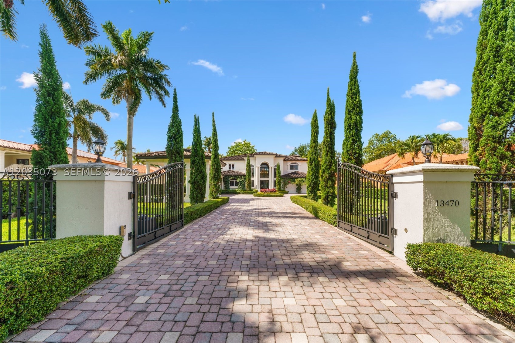 Timeless Elegance Gated Estate — Turnkey & Fully Furnished | 5BD/5.5BA |
This extraordinary custom estate is set on over half an acre of lush, manicured grounds. Offered fully furnished with crystal chandeliers and designer drapery, this turnkey masterpiece is ready for its next discerning owner.
Behind private iron gates, a paver driveway flanked by Italian cypress and sculpted topiary delivers a grand arrival. The Porte-cochère accommodates 4+ vehicles with ample parking.
A soaring two-story foyer with a 9-foot chandelier and marble floors sets the tone for refined interiors. A curved staircase rises to an elegant gallery bridge — a true architectural statement showcasing the split floor plan.
The chef's kitchen features custom hand-carved cabinetry and top-of-the-line appliances. A formal dining room flows into a wine tasting room with coolers for up to 300 bottles. Every bedroom is en-suite with walk-in closets. Primary suites offer private seating and stunning closets. A junior suite with a terrace overlooking the pool and backyard. One room serves as a gym / entertainment space.
Outside, an infinity-edge saltwater heated pool with a dramatic focal-point spa and fountain, large covered terrace, gazebo with summer kitchen, and cabana bath are surrounded by meticulously landscaped grounds with integrated lighting and sound — perfect for resort-style entertaining.
This is not simply a home — it is a statement of lifestyle. Turnkey, timeless, and truly one of a kind.