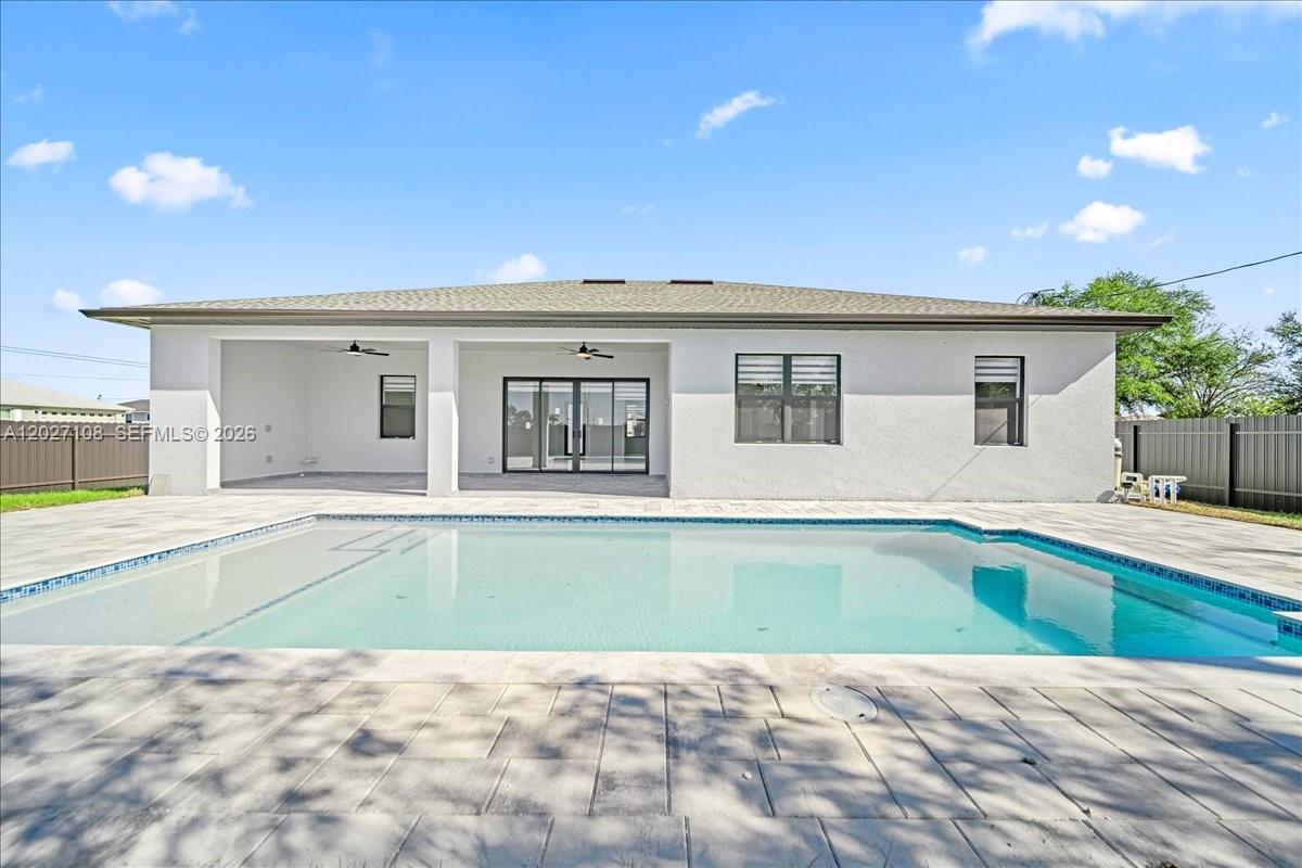 MOVE-IN READY. Discover refined Florida living in this exquisite brand-new 4-bedroom, 2-bathroom residence in Cape Coral. Thoughtfully designed with a contemporary open-concept layout, premium finishes, and sun-drenched living spaces, this home seamlessly blends comfort and sophistication. The private fenced backyard showcases a stunning pool — an entertainer's dream and a tranquil retreat all in one. Ideally positioned near premier shopping, dining, schools, and major thoroughfares. NO HOA. An exceptional opportunity for discerning homeowners and astute investors.
