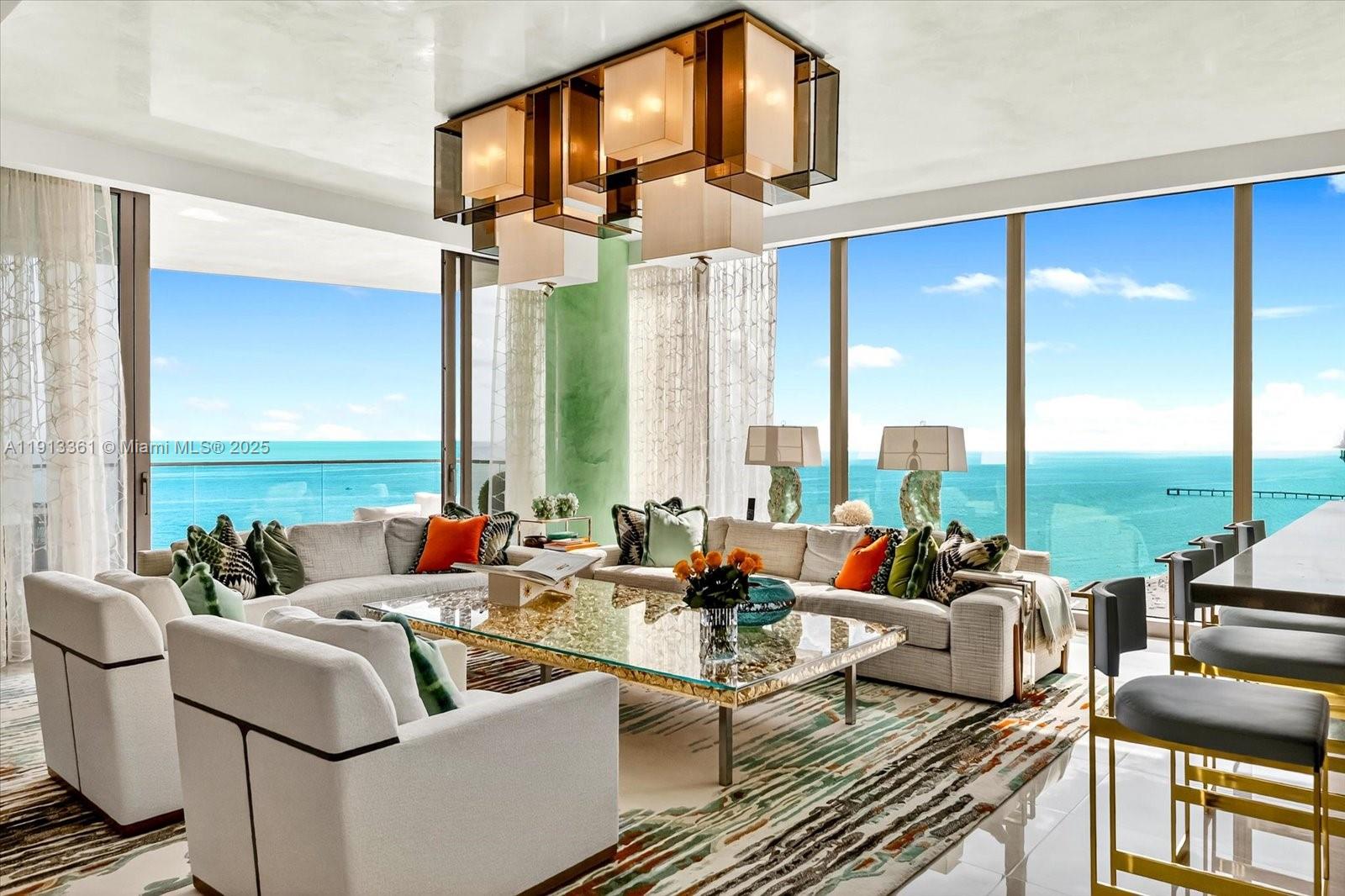 Spectacular south corner residence at The Estates at Acqualina, masterfully designed by the renowned Myron Wolman Designs. From the moment you step off the private elevator, you are transported into a refined tropical oasis. No detail was overlooked—exquisite Venetian plaster ceilings, bespoke wall coverings, custom millwork, designer lighting, curated furniture pieces, and an extraordinary showpiece bar all come together to create a one-of-a-kind atmosphere. This magnificent residence offers the ideal backdrop for sophisticated living and unforgettable entertaining for family and friends. Enjoy the Acqualina Five Star, Five Diamond lifestyle!