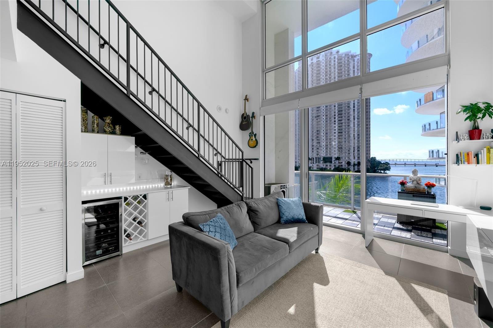 Beautiful and spacious two-story loft with breathtaking views of Biscayne Bay and the Miami River. Truly one of a kind and widely regarded as the nicest loft in the building, offering a layout and design unlike any other. Located in the heart of Downtown Miami, within walking distance to Bayfront Park, Brickell, and upscale dining, shopping, and entertainment—ideal for a live, work, and play lifestyle.
The residence features a remodeled kitchen with Calacatta quartz countertops and stainless steel appliances, a renovated primary vanity, and a spacious den with custom closets. Additional highlights include a convenient half bathroom on the first floor, a custom wine and spirits bar, soaring 20-foot ceilings, and a large balcony perfect for enjoying the stunning city and water views.
Building amenities include a fitness center, sauna, jacuzzi spa, lounge area, office/meeting room, pet wash station,  and resort-style pool. 24-hour concierge and security. Rent includes one assigned parking space, water and sewer, internet, and cable.