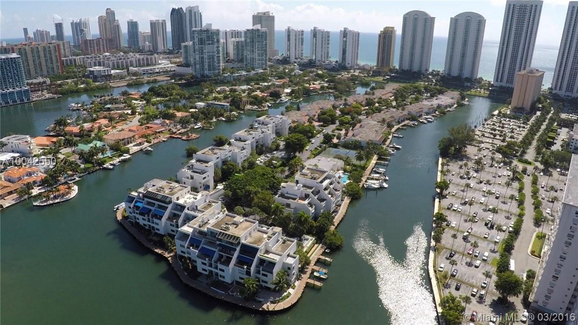 One of the best waterfront locations on the private 24/7 guard-gated community of Poinciana Island. Grand direct views of the main Intracoastal waterway and Oleta State Park Deeded bay bottom included for your boat with no fixed bridges and just minutes t o Haulover Inlet for ocean access. This 3 BR 2 Â½ BTH expanded ground level 2 story marina unit has Brazilian cherry wood floors and white porcelain downstairs and carpeting/wood in bedrooms. Master BR features Intracoastal views and adjacent sitting are