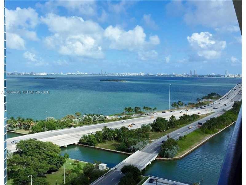 Panoramic Biscayne Bay views set the tone for this elevated 1-bedroom, 1.5-bath residence in the heart of Edgewater. Bright, open layout with tile flooring throughout and a spacious living area flowing seamlessly to a private balcony overlooking the water. Features include an in-unit washer/dryer and ample closet space. Located in a full-service waterfront building with 24-hour security and covered parking. Building undergoing renovations, including installation of impact windows and balcony replacements (most completed). Ideally situated minutes from Miami International Airport, the Design District, Wynwood, the Adrienne Arsht Center, Kaseya Center, and South Beach.
