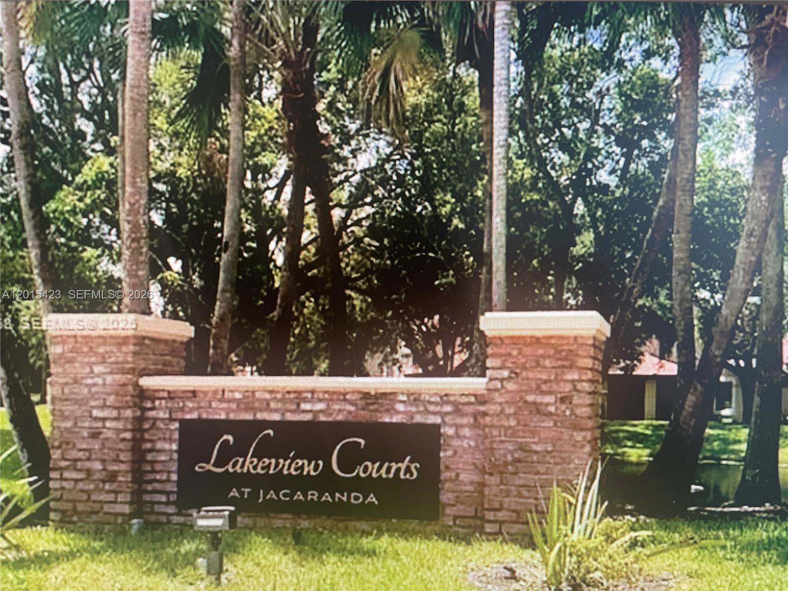 Excellent opportunity to own in desirable Lakeview Courts at Jacaranda community. This 2-bedroom, 2.5-bath residence has new carpet in the bedrooms, tile in the living room and kitchen and has been freshly painted.  Both bedrooms offer private en-suites. This unit has a combination of shutters and impact glass. There is a utility room with outdoor storage and a covered screened in patio. Amenities include community pool and club house in this gated community. Located near shopping, dining, major roadways, and local parks. HOA covers outside maintenance, roof, exterior paint, grass, security. There is a tenant in place until end of July 2026