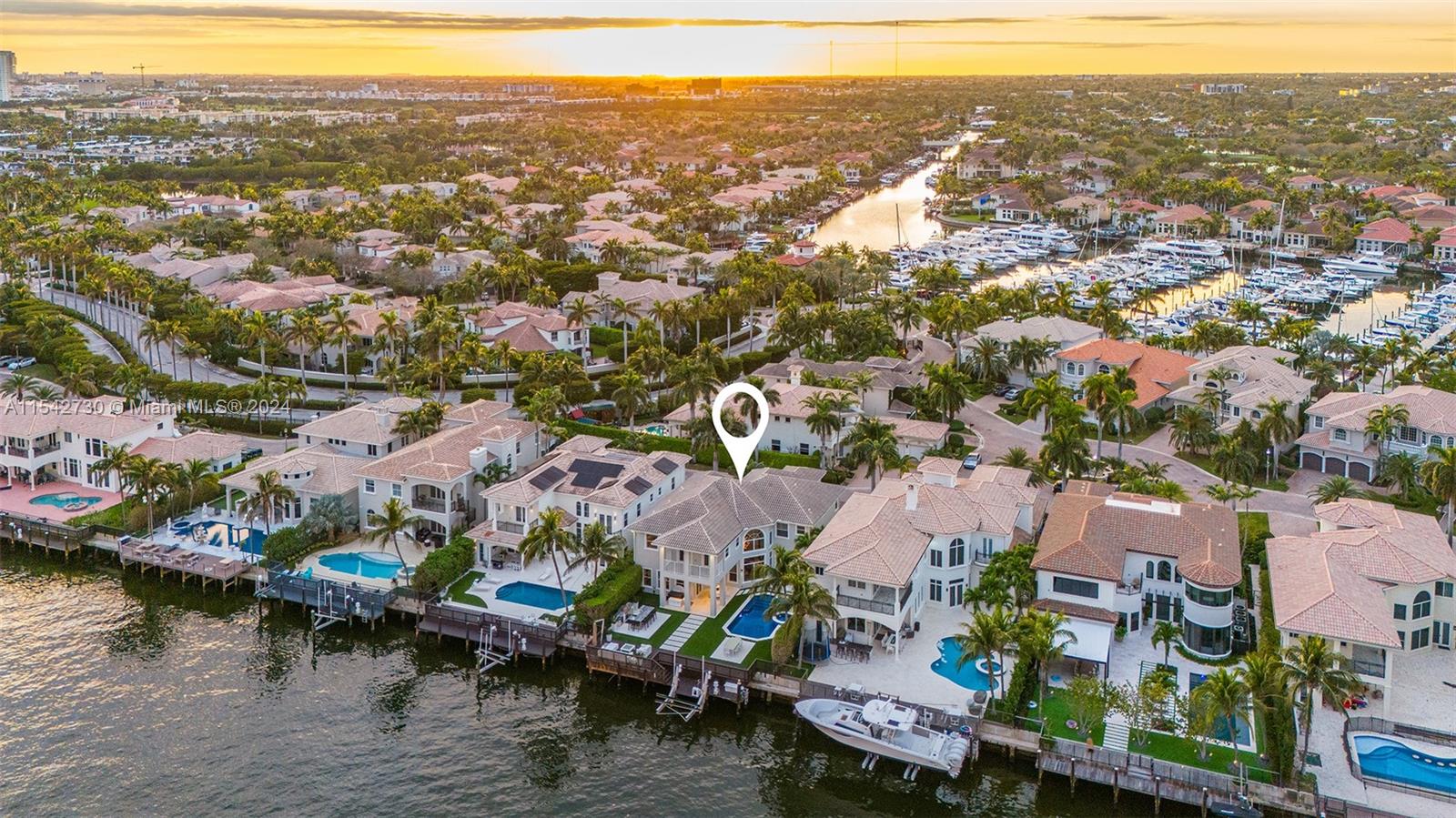Experience waterfront luxury living in the private gated community of Harbor Islands. Boasting numerous luxury upgrades / finishes along the Intracoastal in this 6BR/5.5BA + office/den residence. This large family estate has a large kitchen, with new modern flooring throughout, impact windows and doors, motorized blinds, home automation, 162+ bottle wine cellar, volume ceilings, 3 car garage and more. Outdoors, the essence of entertainment with a heated pool, summer kitchen, synthetic grass, private dock with a 20,000 lbs. boat lift ensures effortless access to the water, all while enjoying panoramic views of passing yachts along the Intracoastal. Great opportunity to live in unparalleled luxury in Harbor Islands.