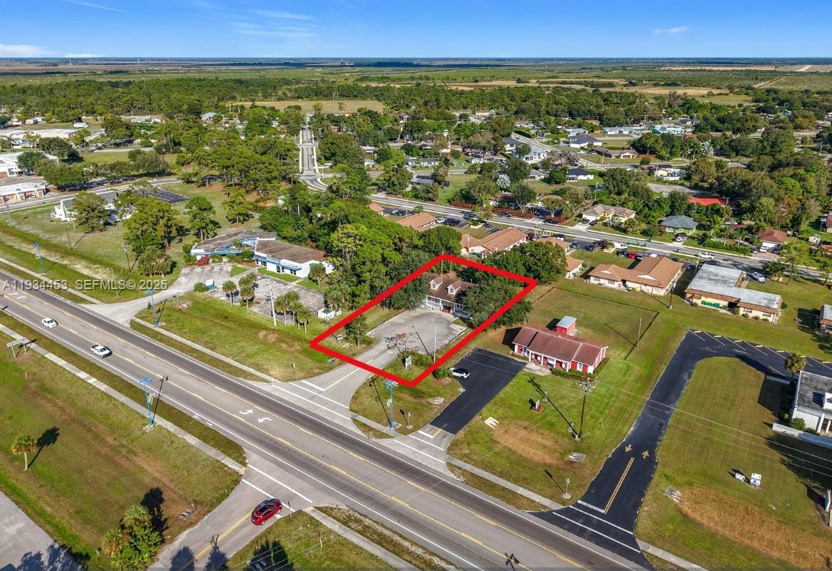 Highly visible and distinctive commercial building on lmmokalee's main highway. Over 3,000 sq. ft. concrete block construction with Old Florida facade, shingle roof, impact windows, and large Southern-style front porches. Two units, each with handicap-accessible restrooms, kitchenettes, and storage. Ample paved parking. Two central AC units plus mini-split in south addition. Currently used as insurance office and photography studio. Excellent exposure and flexible space for owner-user or investor.