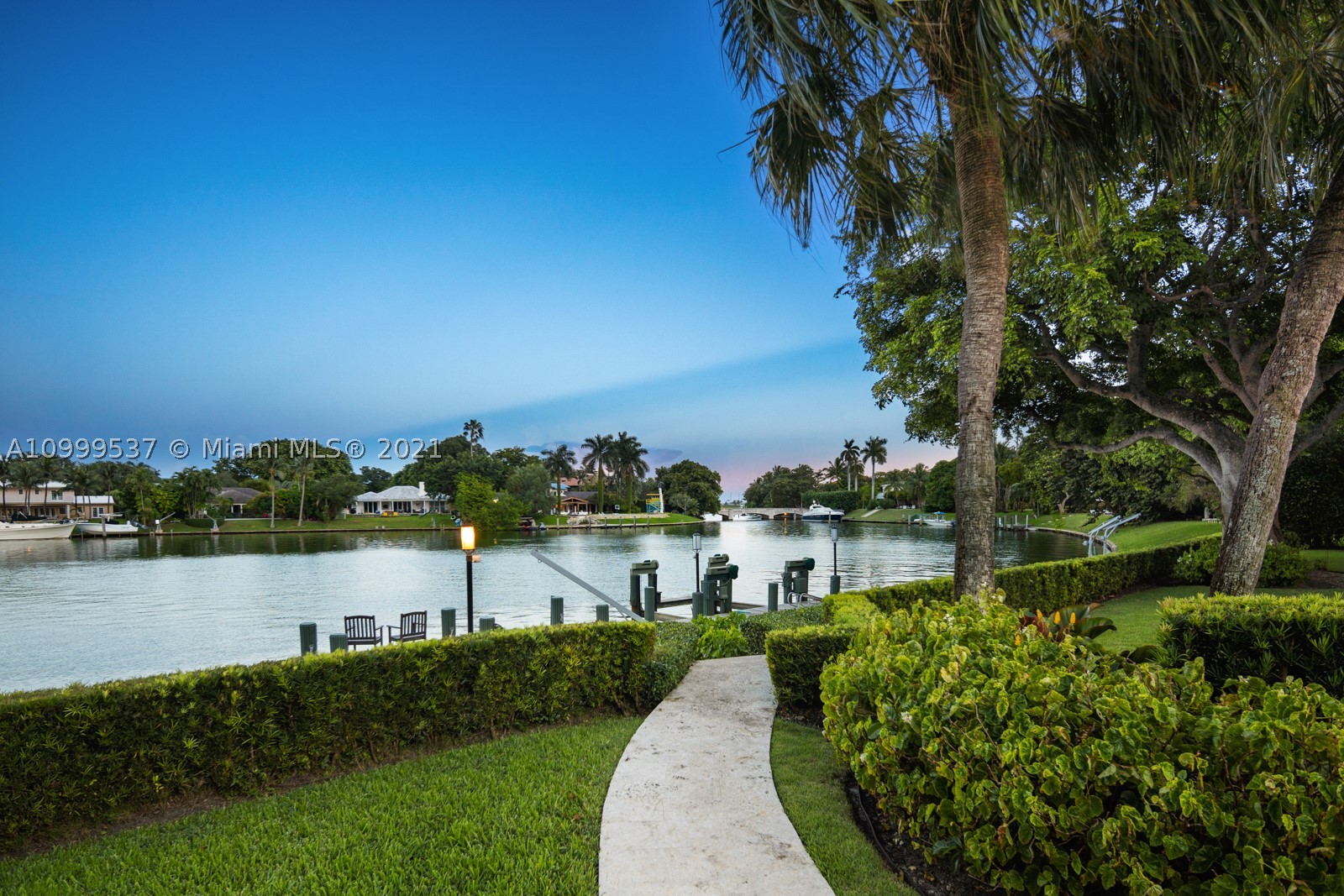 Nestled in the exclusive gated community of Bay Point, this stunning lakefront estate offers some of the most spectacular views right from the backyard. Stylishly renovated with modern touches keeping its original charm, this is the perfect place to call home. Boasting a split floor plan, spacious master suite with double height ceilings and a sitting room with fireplace, gym, private upstairs office with a full bath & library. An entertainers paradise with a large formal dining room & expansive living area with full bar. Enjoy the privacy and serenity as you enter the property with lush landscaping and mature trees throughout. The neighborhood of Bay Point is in the heart of Miami with easy access to nearby Midtown, The Design District, Wynwood, and Biscayne Blvd.