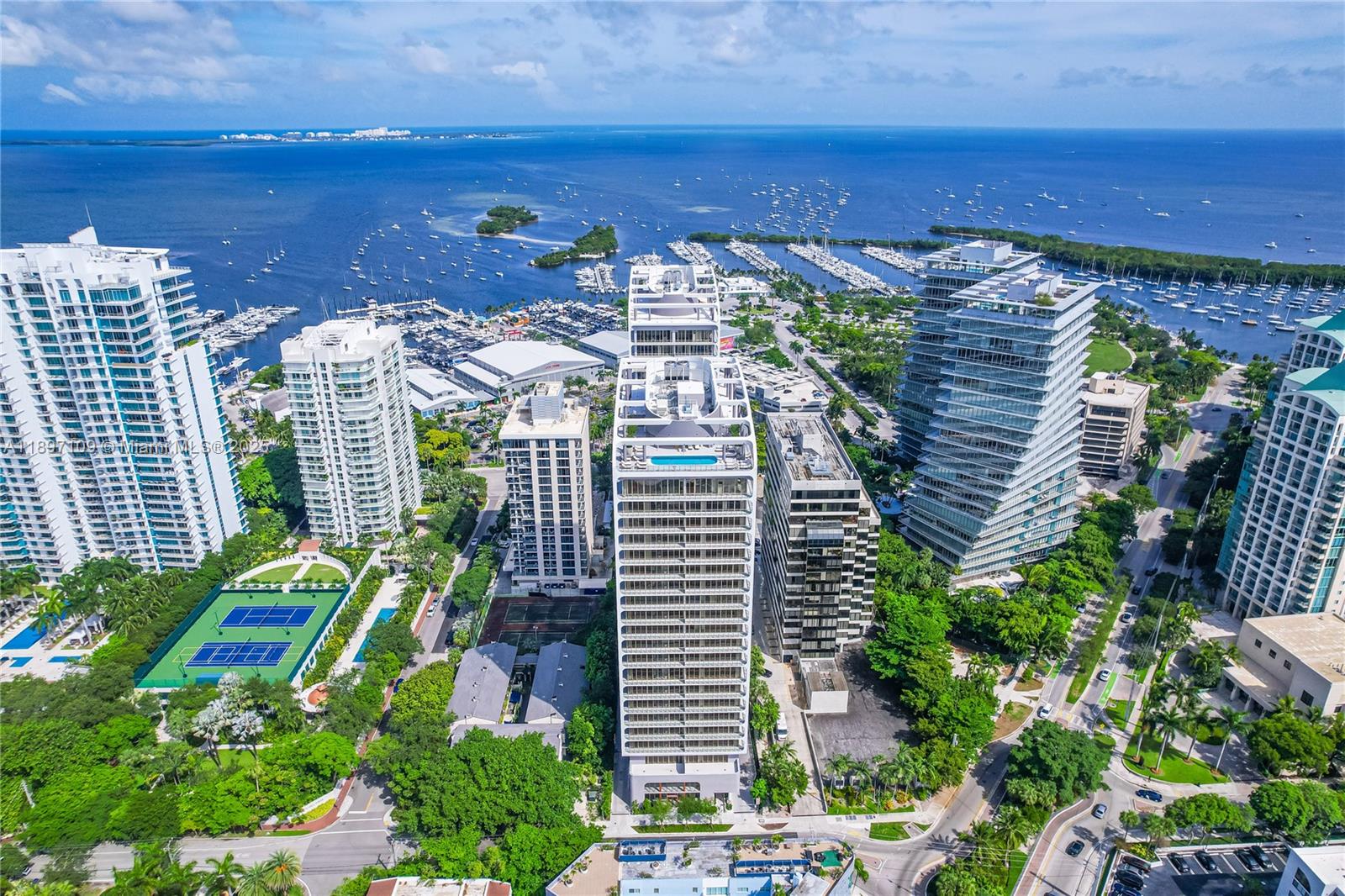 Unit is currently rented through December 2026, buy today and start collecting rental income. 3 deeded tandem parking spaces in covered parking garage included. Parking for EV vehicles available & valet.  Pet friendly building! An exquisite opportunity to embrace waterfront living in brand new development(2024) known as Mr.C Residences "Bayshore Tower", located within the booming neighborhood of Coconut Grove. Step into a world where sophistication meets comfort, 2 bedroom 2.5 bathroom condo has 1046 SQ FT of living space w/170 SQ ft of balcony space, 11FT high ceilings w/ views from Biscayne Bay & Miami's finest skyline. Amenities: pool/spa for residents in the tower, business center, fitness center, sauna, children's play room, library & full service concierge reception, Butler service, 24 hour security, Italian market + eatery.