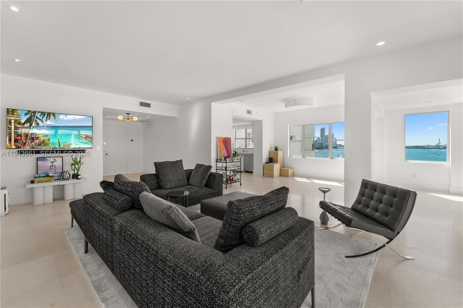 Modern 7th-floor unit with 9 ft ceilings offering light, bright, and spacious living with sweeping bay views from all rooms. Updated condo with modern finishes, two large ensuite bedrooms featuring marble baths, and generous closet space. Includes a versatile office/den area for added functionality. The open corner balcony boasts built-in seating, perfect for relaxing and enjoying the views. Hurricane windows throughout ensure safety and style, complemented by white limestone floors in living areas and new carpeting in bedrooms. Enjoy covered parking with valet for guests, a heated pool, BBQ area, and available boat dock space. While tax records indicate 1,570 sq/ft, revised measurements confirm a more generous 1,925 sq/ft space.