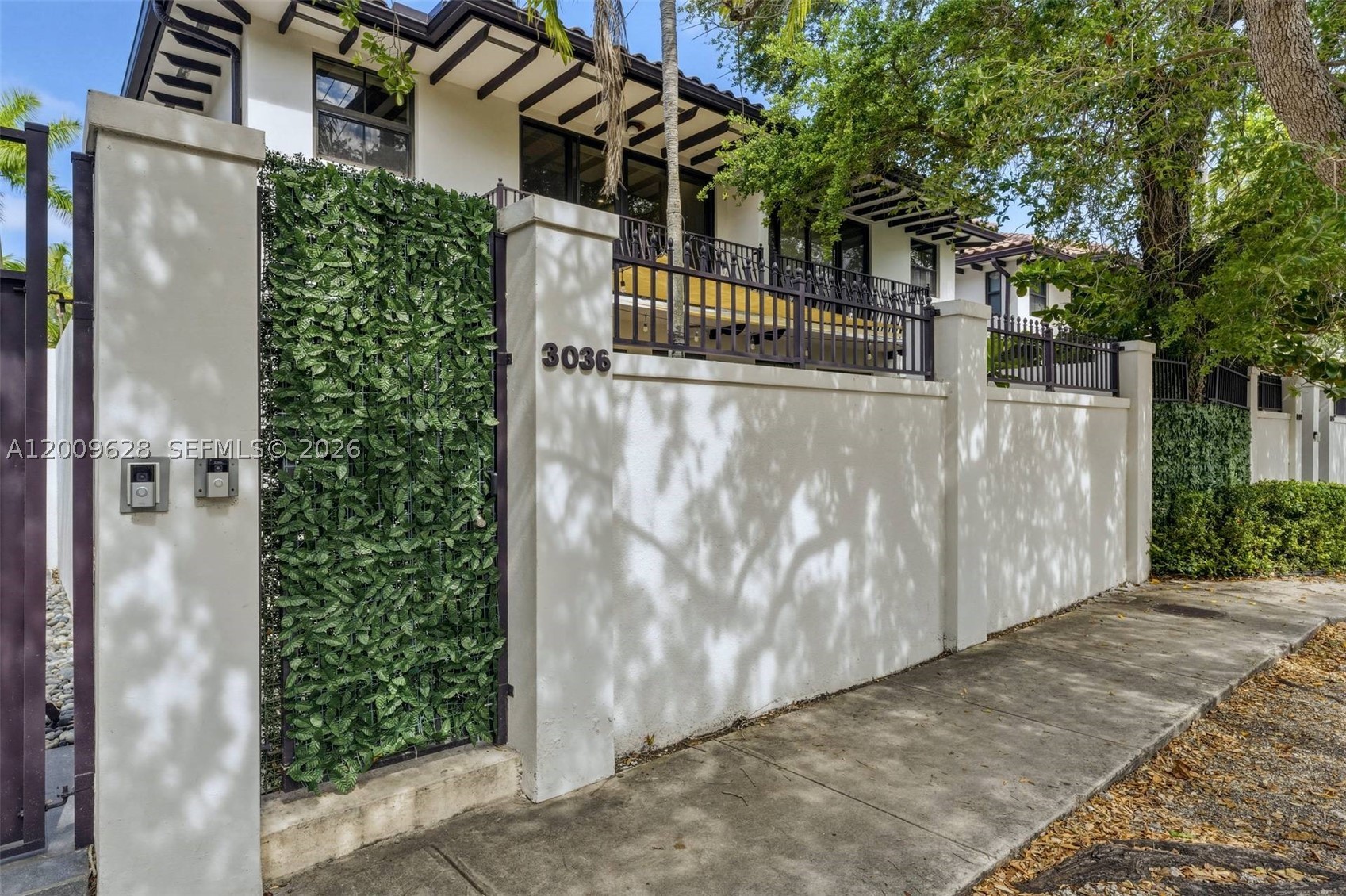 Introducing “Maison Du Jardin,” a meticulously curated 2,350 SF residence offering refined design, smart home integration, and exceptional indoor-outdoor living in the heart of Coconut Grove. This two-story townhouse features 3 bedrooms, including two expansive primary suites, plus a dedicated office or guest bedroom. White oak solid hardwood flooring runs throughout, complemented by custom built-ins, spacious walk-in closets, and remote-controlled blackout shades. The designer kitchen is the centerpiece, showcasing custom walnut cabinetry, Taj Mahal quartz countertops with full-height backsplash, and an 11-foot island with seating for six. Premium appliances include a Wolf gas range, KitchenAid refrigerator, Bosch dishwasher, and Monogram wine fridge. All three bathrooms feature high-end Kohler fixtures. The primary suite offers a spa-like retreat with a double vanity, quartzite finishes, oversized dual shower, and a Toto bidet, while the second suite features a soaking tub and a walk-in shower.  Smart home features include Nest, Google cameras, Lutron lighting, Sonos audio, Cat 6 wiring, and app-controlled systems. A 2-car garage with a Tesla charger adds convenience. Enjoy a private garden oasis with mature fruit trees, lush landscaping, and a 6-person hot tub. Residents access Grove Enclave’s saltwater pool, spa, and summer kitchen. 2023 roof, impact windows, low HOA.