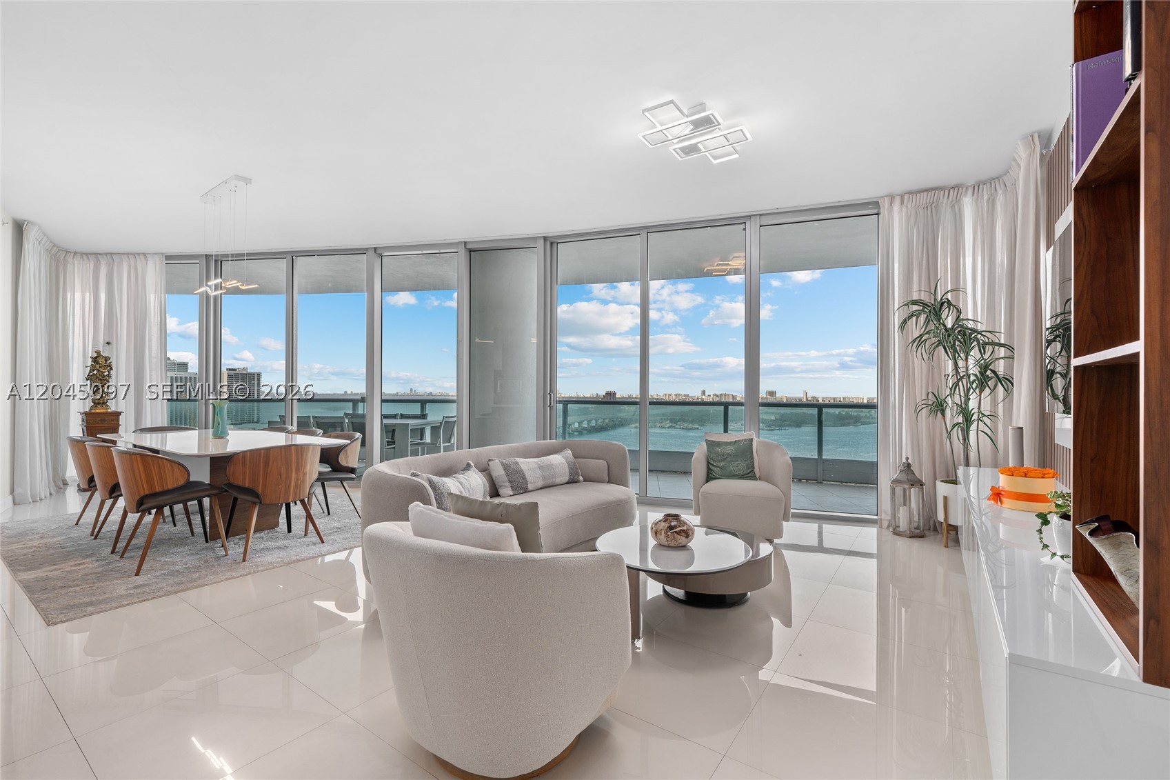 Sky-high living at 900 Biscayne. Welcome home to the 25th floor of 900 Biscayne, where Miami's skyline and bay meet in every direction. 
This spacious 3-bedroom, 4-bathroom plus den residence offers soaring floor-to-ceiling glass walls, filling the home with natural light and unobstructed views of Biscayne Bay, the Port of Miami, and the city skyline beyond. The thoughtful split-bedroom layout gives every room water views, and its own sense of privacy, with bedrooms positioned away from each other and from the main living space. The open concept living and dining area flows seamlessly onto a wraparound terrace, perfect for entertaining or simply taking in the neverending views over the water. The sleek, European-style kitchen features high-end stainless steel appliances, quartz countertops, ample cabinetry and several upgrades. A rare combination of space, light, and location makes this an elevated city living at its finest. Polished, modern, unforgettable.