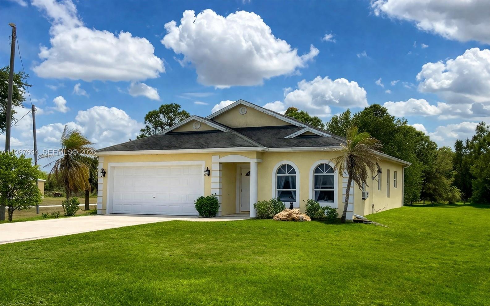 Stunning and uncommon cathedral ceiling design in Clewiston, Florida.  A beautifully built concrete home located in the desirable Montura Ranch community. This property offers 3 bedrooms, 3 full bathrooms,, with approximately 1,630 sq ft of living area. Sitting on a spacious 0.95-acre lot, it provides plenty of room for outdoor enjoyment, expansion, or simply enjoying the privacy that characterizes the area. What truly makes this home stand out is  a rare feature in Montura that creates an open, elegant, and airy feel throughout the main living spaces, enhancing natural light and overall architectural appeal. The home features durable ceramic tile flooring throughout and an asphalt shingle roof, combining practicality with style. In addition, it includes an attached 2-car garage and a wide paved driveway offering ample parking. This property is ideal for buyers looking for a solid construction home with a unique and eye-catching design, generous land, and the peaceful lifestyle that Montura Ranch is known for.  NO HOA.