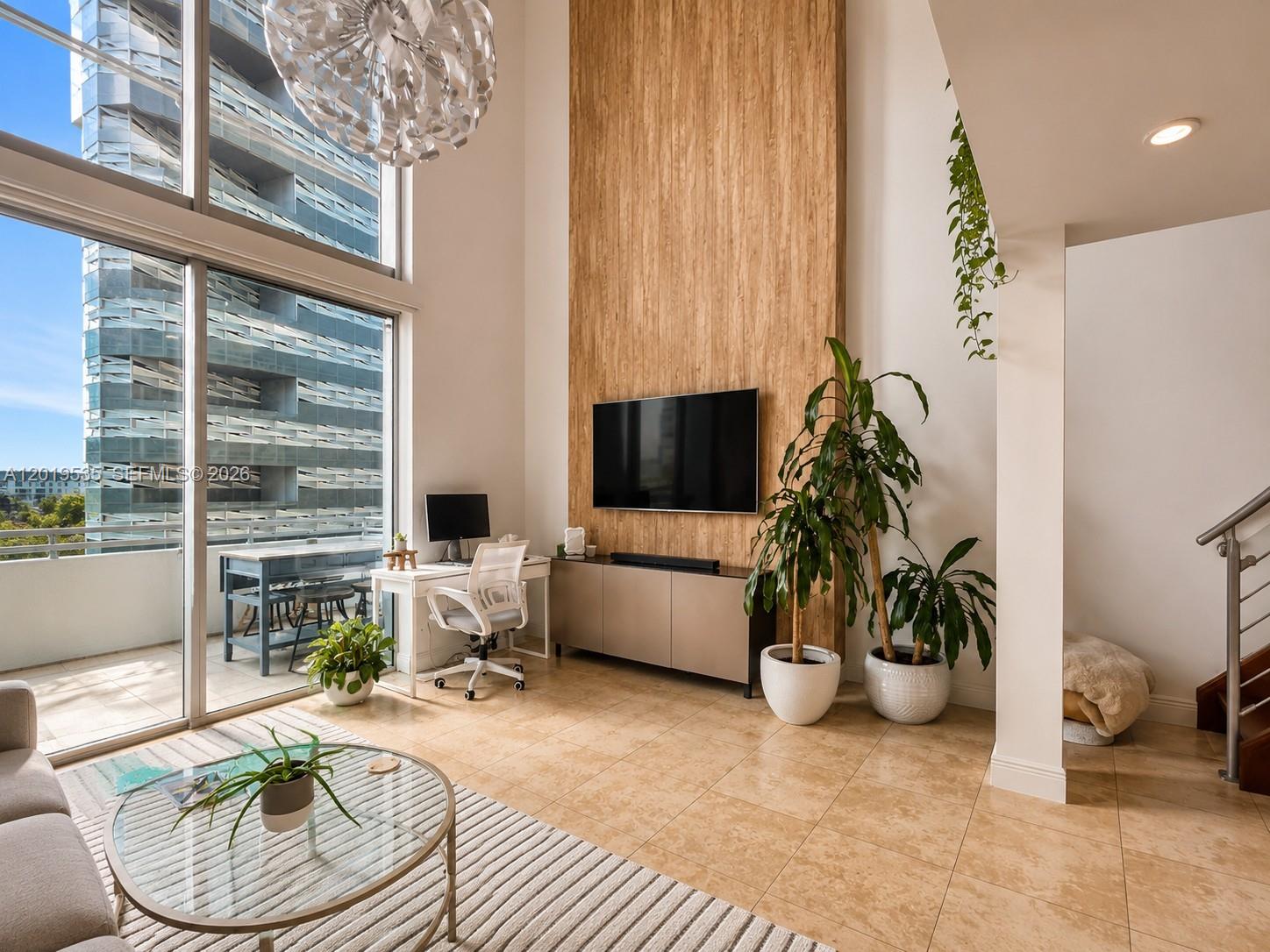 Experience elevated urban living in this stunning loft featuring a bright, open-concept design with dramatic double-height ceilings and sleek porcelain flooring throughout. Natural light floods the space, enhancing the modern aesthetic and airy feel. The upper level offers a private primary bedroom retreat, a versatile den thoughtfully converted into an oversized custom walk-in closet, and a full bathroom. On the main level, enjoy a spacious living and dining area perfect for entertaining, an open kitchen with upgraded white quartz countertops, and a second full bathroom for added convenience. Step out onto your private balcony — ideal for morning coffee, evening relaxation, or hosting guests. Located just steps from Mary Brickell Village, Brickell City Centre, and the Metro-Mover, this residence offers unbeatable walkability and access to world-class dining, shopping, and entertainment in one of Miami’s most desirable neighborhoods. A perfect opportunity for end-users or investors seeking style, location, and value in the heart of Brickell