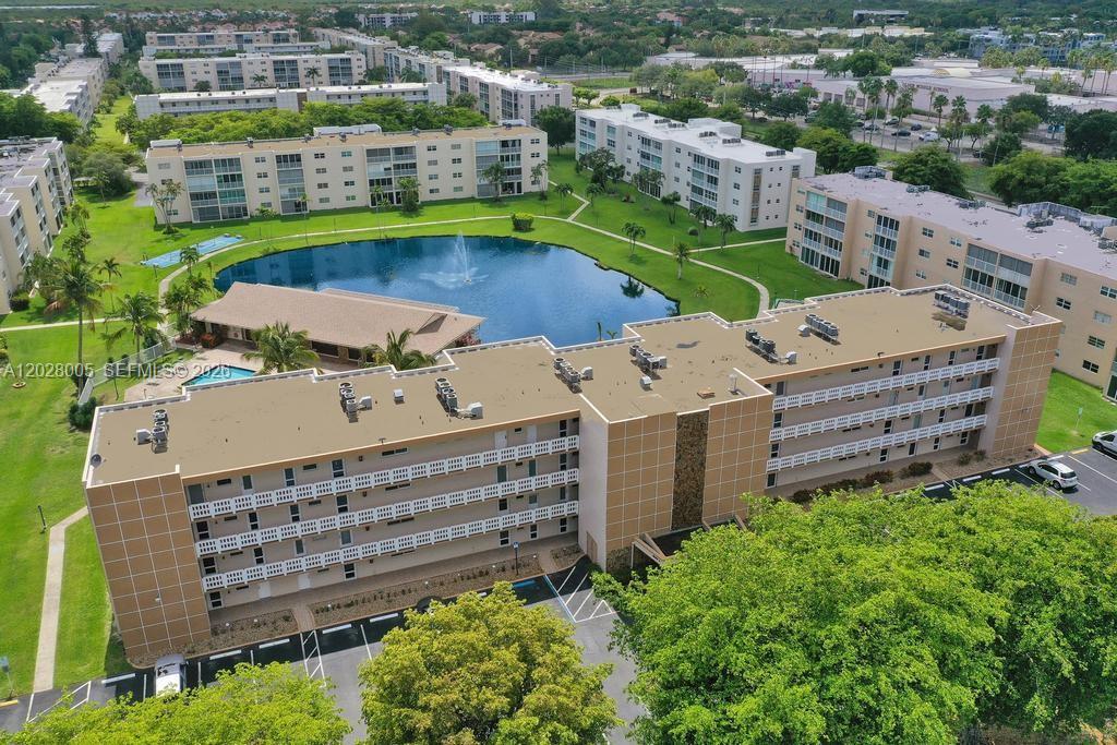 Fully updated corner unit adds privacy and lots of natural light. Same tile flooring throughout. Washer & dryer in the unit! Impact windows and doors provide both style and peace of mind. Furniture, dishes, etc. can be included. Serene lake views enhance the home's tranquil setting. Peaceful, friendly, active adult community with pool and clubhouse. Reserved parking directly in front of the residence offers exceptional ease.  One reserved parking space and also ok to use one guest space on a permanent basis. OK to lease, minimum 90 days, 1 time per year, after 1 year of ownership. Ideally situated near grocery stores, shopping, dining, the beach, golf, tennis, and casinos, with convenient access to both Fort Lauderdale and Miami.