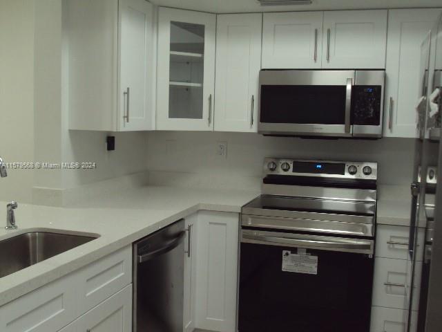Completely remodeled ground floor unit located at Kenland Pointe II. This 1200 sq. ft. apartment has nice covered deck for entertaining. Unit has been completely remodeled with an open checkbook. Brand new kitchen cabinets with a large custom pantry and Samsung SS appliances never used. Quartz countertop. The bathrooms have been remodeled with a modern flair. Some other upgrades include: New Samsung Washer and Dryer, Baseboards, New AC, New Water Heater, freshly painted, custom vanity in the master. Unit 109P has to many options to list including separate storage area on the ground floor. Plenty of non assigned parking and is nestled between both Baptist hospitals and just one block away from the Florida Turnpike and Town and Country. Will lease fast. Separate storage unit also included