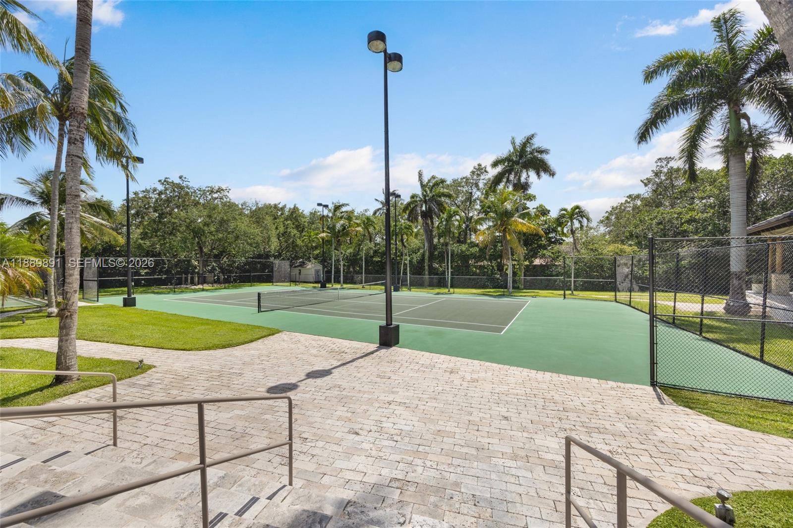 A rare offering in a rapidly evolving enclave, indulge in a private Miami resort lifestyle at Farmer Road Estate, a gated 2.16-acre sanctuary in north Palmetto Bay, minutes from Pinecrest. Designed for gathering, recreation, and multigenerational living, this estate offers the land, scale, and setting that are increasingly difficult to recreate. Elegant interiors showcase intricate woodwork and dramatic arches, while expansive terraces, and lighted tennis and basketball courts create a destination experience where a long weekend feels like a getaway. Amenities include a billiard room, sauna, gym, kids' loft, outdoor bar, BBQ gazebo, and a private 3-bedroom guest wing. Andersen windows and doors, a Viking kitchen, and a 2025 metal roof complete this exceptional legacy property.