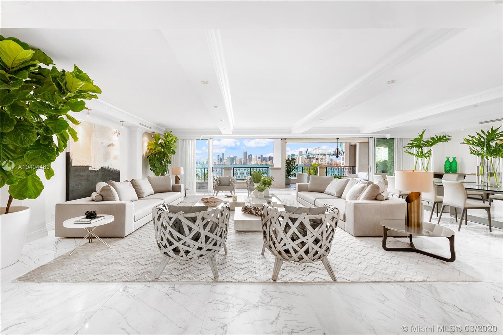Entering this residence you are greeted by a tranquil private garden terrace w/fountain & views to S. Beach. The foyer leads to large living & dining areas w/flow-through layout & walls of glass extending to a grand bayside terrace w/ unobstructed views to Biscayne bay & Downtown skyline. The contemporary, fully renovated 4BR/4+2BA Bayview home boasts 6300 SF, custom design finishes & exquisite Thassos marble floors. A gourmet kitchen sports top-of-the-line appliances, Allmilmö cabinetry/granite Center Island. The sumptuous master suite features step-out terrace access w/bay views, his/her master bath w/sunken spa tub, steam shower & voluminous his/her walk-in closets. 3 car-parking spaces in underground garage plus 2 golf cart spaces, and one new Garia golf cart included with this sale.