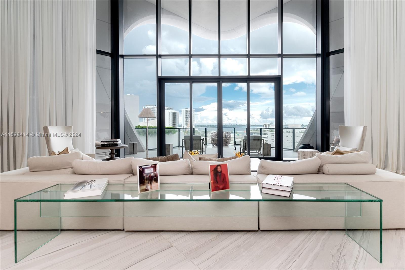 Discover unparalleled luxury in this 5-bedroom residence at One Thousand Museum by Zaha Hadid. As you enter the private elevator foyer, you are greeted by a grand entrance that seamlessly flows into an expansive living area, boasting floor-to-ceiling windows that provide panoramic views of Biscayne Bay, the Atlantic Ocean, and the vibrant Miami skyline. The open-concept layout is perfect for entertaining, featuring a spacious living room, a formal dining area, and a state-of-the-art kitchen equipped with custom Italian cabinetry, high-end appliances, and a large island with a breakfast bar. Exclusive amenities include a rooftop helipad, indoor and outdoor pools, a wellness spa, and 24/7 concierge services. This is the epitome of sophisticated urban living!