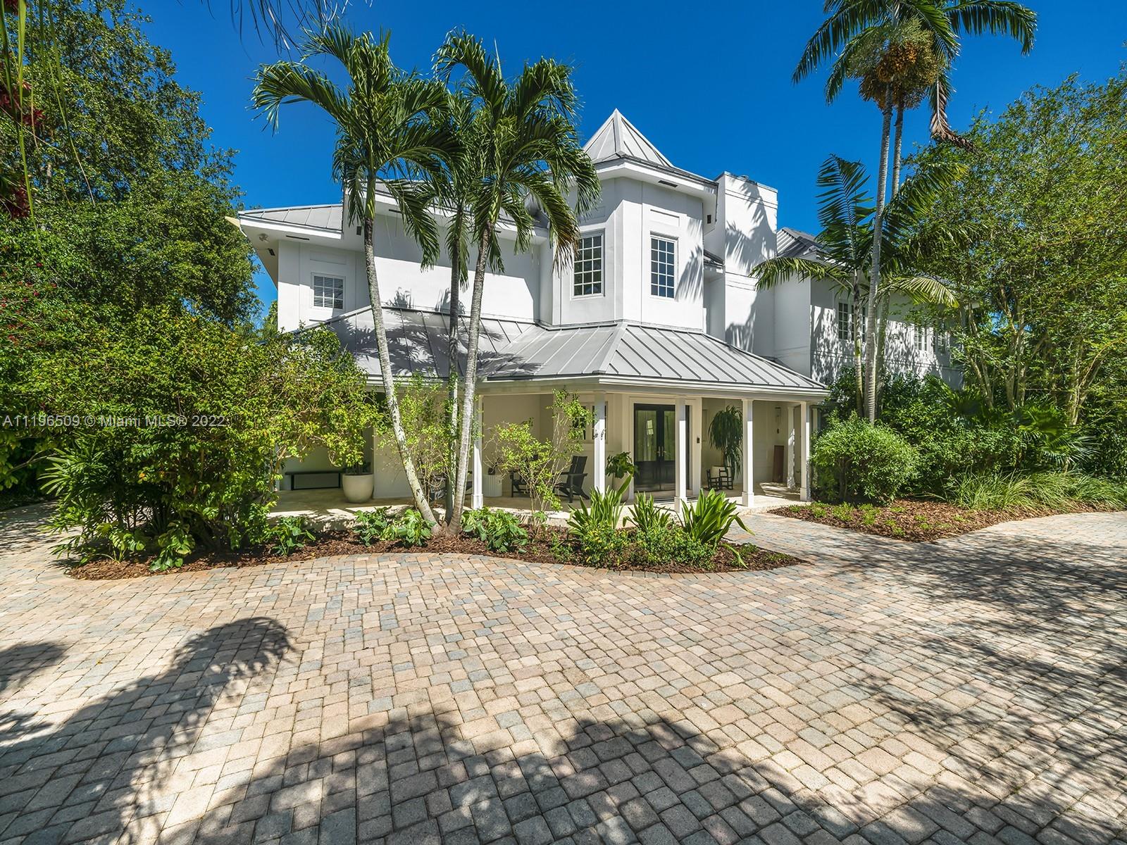 Stunning Key West Style home situated in heart of N Pinecrest, commanding a premium picturesque lushly landscaped lot. Elegant & stately residence, completely remodeled w/sophistication & infused w/modern zest. Discover a welcoming foyer, volume ceilings & an expansive flrplan. Desirable formal living rm, elevator, family rm, dining rm & home office. Fabulous chef’s kit featuring Miele/SubZero appl, breakfast area & wet bar. Enjoy an upstairs gathering space, lavish master w/sitting area, soaking tub, 2 WIC, huge decked terrace & 3 ensuite bedrms. Indulge in a spectacular resort-style outdr entertaining, w/covered patio, wet bar, half Olympic size pool, exotic fruit trees & an oversized yd. Add’l features: gym/office/storage rm, imp win/drs, metal rf, 40 solar panels, 2 car gar & carport.