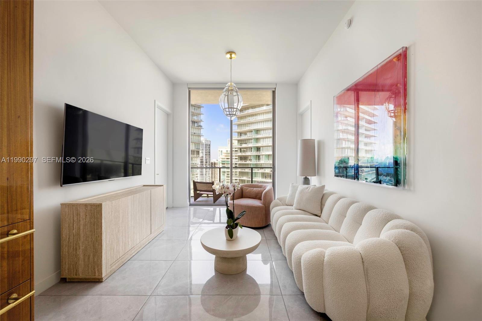 A refined residence at Mr. C Residences, offering elevated living in the heart of Coconut Grove. This 2-bedroom, 2-bath home features 1,046 sq ft of open, light-filled interiors with 11-ft floor-to-ceiling windows and seamless indoor-outdoor flow to a 170 sq ft private terrace and wraparound balcony with sweeping water and city views. The Italian kitchen is appointed with terrazzo quartz countertops and Wolf appliances, complemented by marble and European porcelain floors, solid core doors, and yacht-inspired detailing throughout. Residents enjoy resort-style amenities, a renowned in-building restaurant, 24-hour concierge, and full-service lifestyle management, all within a meticulously maintained building just moments from parks, marinas, the yacht club, and top-rated schools.