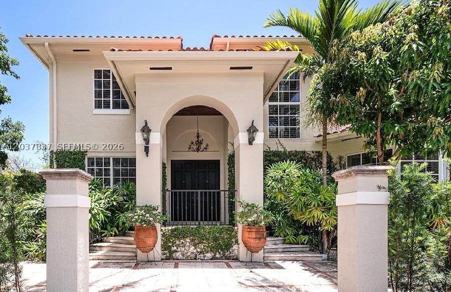 Beautiful elevated Mediterranean-style residence offering 5 bedrooms, 4.5 bathrooms, plus a den/office, surrounded by lush tropical landscaping that creates a true private oasis. Situated on a desirable corner lot, the property features a heated pool and expansive patio area, complemented by winding paved pathways framed by exotic palms, lychee and mango trees.
With approximately 3,929 SF of living space, this elegant home showcases marble floors throughout, a gourmet kitchen with custom wood cabinetry, granite countertops and stainless-steel appliances, as well as spacious formal living and dining areas designed for both entertaining and everyday comfort.
Additional highlights include a library, private office/den, generous bedroom accommodations, a two-car garage, and abundant natural light throughout. Combining timeless Mediterranean architecture with exceptional indoor-outdoor living, this residence offers the perfect setting to enjoy the island lifestyle.