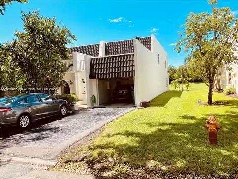 This beautiful and spacious corner unit town-home has over $100K of recently completed upgrades and is in one of South Miami's best gated communities. Only 100 units in the community.  2 oversized bedrooms and 2.5 baths boasting 1,780 sq ft of open floor plan. Travertine flooring throughout the home with dark wood flooring on the stairs and landing. Two master suite bedrooms with 2 full baths in each bedroom. A half bath for guests on the first floor. Upgrades include the opening up of the entire first floor to create an open floor plan, completely new quartz based kitchen and an oversized island with storage, entirely new bathrooms and an oversized new HVAC unit. This Gem will not Last!