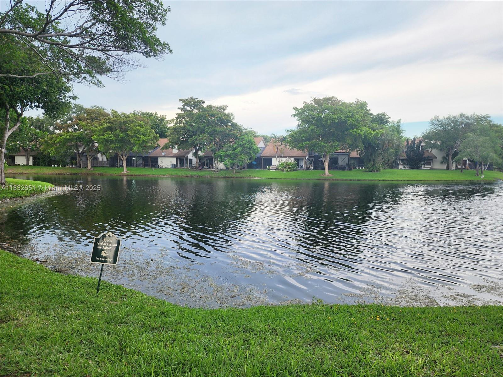 Plantation at Wimbledon Lakes- 2/1.5 unit located on the first floor, parking in front, corner unit with pretty views of the lake and garden. Tile floors very light and bright. Accordian Hurricane shutters. Central Broward location with great restaurants, shopping and schools nearby