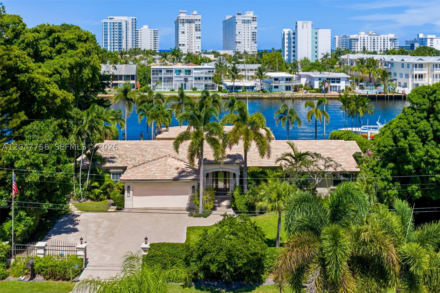 Wake up to the water. Nearly half an acre with 132 feet of direct Intracoastal frontage. Heated pool, large yard and east-facing patios open onto a 300-foot-wide channel and the steady parade of boats heading out to sea. No fixed bridges and less than three miles to the Hillsboro Inlet, with unrestricted ocean access and dockage for a yacht up to 117 feet. The interior lives up to the setting. The water-facing primary suite opens through 15-foot pocket doors to a patio with a gas fireplace. Chef's kitchen built around a full Sub-Zero and Wolf suite. Control4 smart home controls lighting, whole-house A/V, and a home theater with a 90" 4K HD screen and eight-channel surround sound. Ten-camera security, two-zone climate, tankless gas hot water. Impact glass throughout, and a whole-house generator. Extra-wide two-car garage and additional parking behind a private gated entry.
Turnkey and ready in the heart of Pompano—on waterfront that rarely trades.