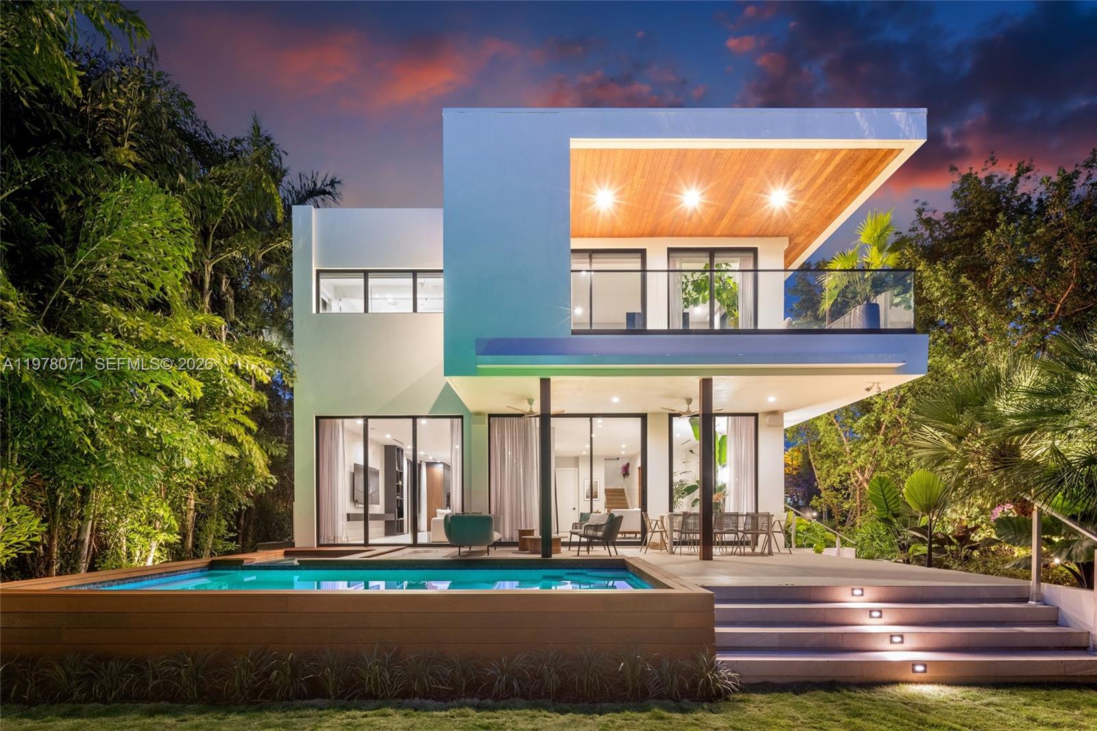 Recently reimagined with a comprehensive landscape and outdoor living transformation by Nielsen Landscape Architecture, this refined modern residence on Miami Beach’s prestigious North Bay Road now offers a level of privacy and resort-style living rarely found in the area.

Positioned on a prime corner lot and filled with natural light, the 4-bedroom, 4.5-bathroom home is defined by a clean, open-concept layout designed by Praxis Architecture & Design. Interiors are defined by custom millwork, high-end materials, and tailored functionality, thoughtfully enhanced by Barbis Studio to create a refined and cohesive design language throughout.

The fully transformed outdoor environment unfolds as a layered tropical landscape, anchored by mature specimen palms, a 15-foot bridal veil tree, 18-foot bamboo, and a 13-foot Clusia hedge for exceptional privacy. 30-foot buttonwood trees frame the front of the property, enhancing privacy and creating a lush, established arrival experience. A Coralina paver garden pathway with turf inlays weaves through the grounds, creating a sense of movement and discovery, while Ipe-clad pool decking, architectural lighting, and multiple lounge areas complete the setting. A saltwater pool and spa, covered terrace with a custom KE retractable awning, Haiku ceiling fans, and integrated outdoor surround sound create a fully immersive tropical retreat for both entertaining and everyday living.
