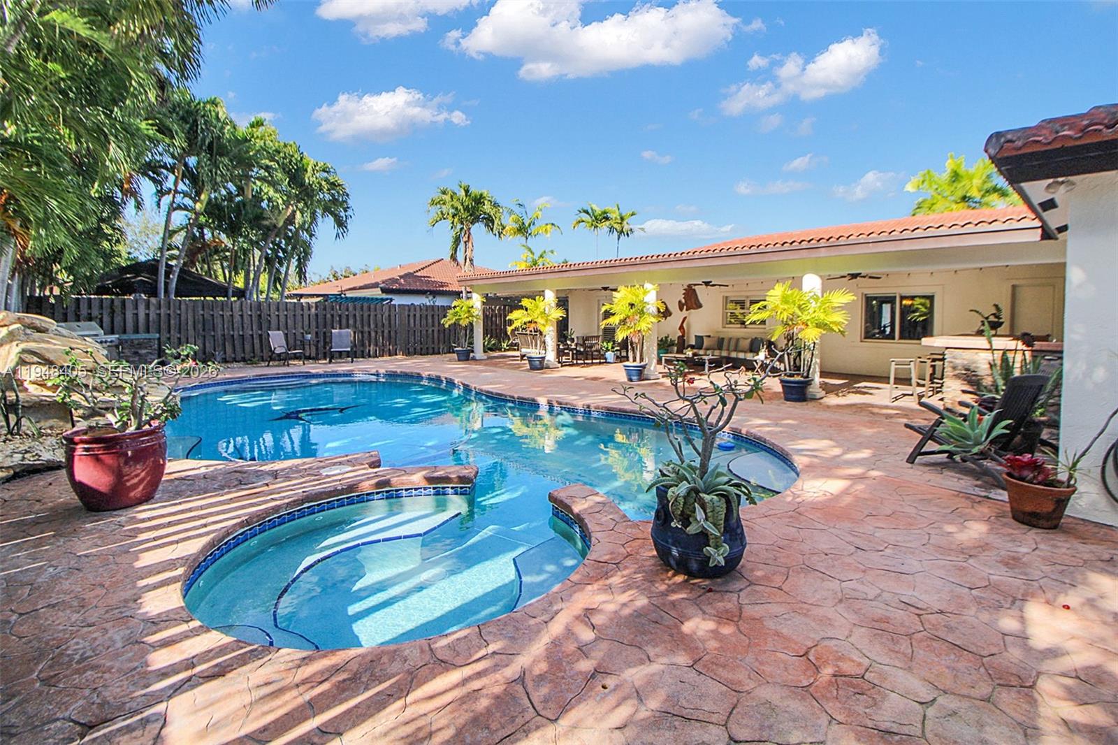 Spacious Cutler Bay pool home featuring a layout larger than the tax roll. This 4-bedroom, 3-bathroom residence offers a versatile floor plan designed for privacy and functionality. Highlights include two primary suites, one with a private exterior entrance ideal for guests or multi-generational living. The interior boasts multiple living areas and a kitchen with wood cabinetry and Corian countertops that opens to the main living spaces. Step outside to a sparkling pool and an expansive patio perfect for year-round entertaining, complemented by a great shed for additional storage. Tucked away on a quiet cul-de-sac, just minutes from shopping, dining, and major highways.