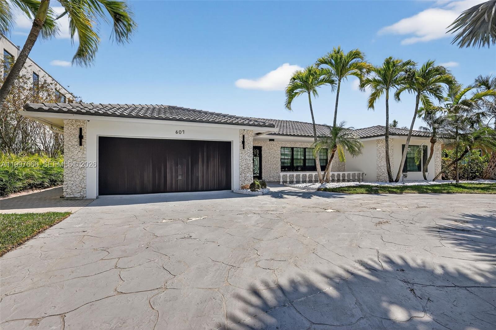 Stunning 5 bedroom / 4 bathroom home located in the desirable Golden Isles waterfront community, featuring 84 feet of private dockage on a wide canal with ocean access and no fixed bridges. This residence offers an open floor plan with abundant natural light and water views throughout. The kitchen is finished with high-end design, a spacious island, and flows seamlessly into the main living areas, making it well-suited for both everyday living and entertaining. The home includes three en-suite bedrooms, providing comfort and privacy. Bathrooms with modern finishes and a clean, contemporary design. Enjoy a covered outdoor living area overlooking the water, perfect for relaxing or hosting while taking in the tranquil waterfront setting. An excellent opportunity for boaters and those seeking a beautiful home in a prime location close to shopping, dining, and major roadways.