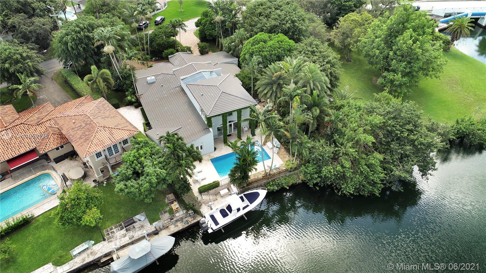 Oversized corner lot in the heart of Coral Gables, a stunning waterfront masterpiece featuring cathedral ceilings and open living areas.  Completely renovated, new roof & Surrounded by light, grand entrance opens to a large living room with a working fireplace, wine cellar, wet bar, & formal dining. To the left, it opens into a European style kitchen, laundry room, nanny’s quarter & air conditioned one-car garage with extra storage and convenient workspace.  Integrated AV system, programmable lighting & security cameras. Family room overlooks the pool area and waterway. Two master bed suites & dock with boat lift (32 feet /16,000lb max).  The staircase is the centerpiece of the home, capped with impact resistant skylight leading to the master suite that includes sitting area &two terraces.