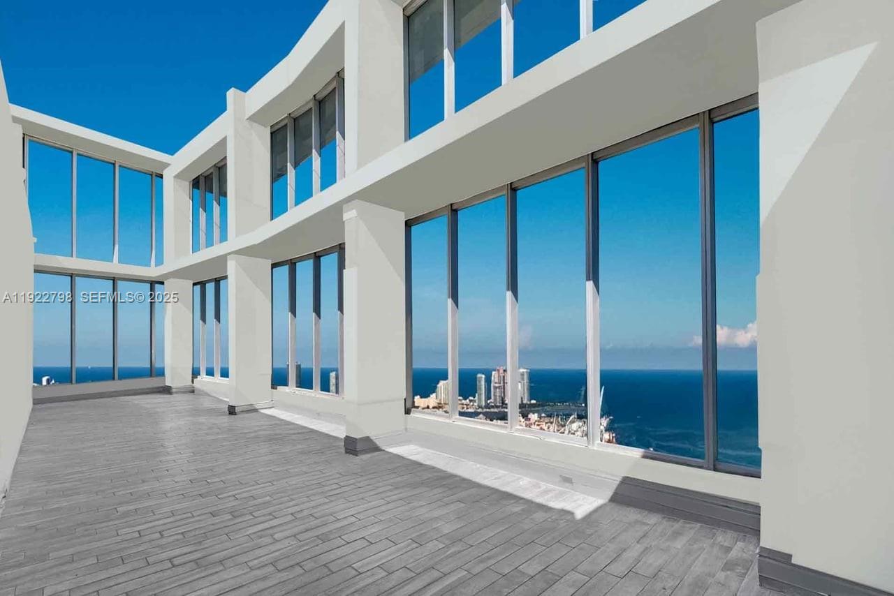 Perched high above the energy of Brickell, this exceptional Sky Mansion rises as one of Icon Brickell’s most commanding penthouse residences. Moments from Brickell City Centre and surrounded by the pulse of Miami’s global lifestyle, the home offers more than 4,500 square feet of beautifully curated living space, wrapped in sweeping 280-degree views of Biscayne Bay, the Atlantic Ocean, and the city’s iconic skyline.
Expansive floor-to-ceiling glass frames every vista, drawing natural light into each room and creating a seamless connection between sky, sea, and design. The residence features five private suites, each offering a tranquil retreat elevated by refined finishes and generous scale.
Two enclosed terraces—totaling an impressive 1,500 square feet of outdoor living—extend the experience outward, providing the perfect backdrop for dining, entertaining, or simply taking in the ever-changing horizon.
At the heart of the home, the gourmet kitchen blends elegance and function with Florense custom cabinetry, Sub-Zero refrigeration, and Taj Mahal quartzite countertops, creating a culinary setting worthy of the views that surround it.
Thoughtfully designed and masterfully executed, this residence represents luxury at its most elevated. A rare opportunity to own one of Icon Brickell’s most significant penthouses, offering privacy, scale, and a vantage point unlike any other.

The images has been digitally altered for virtual staging.
