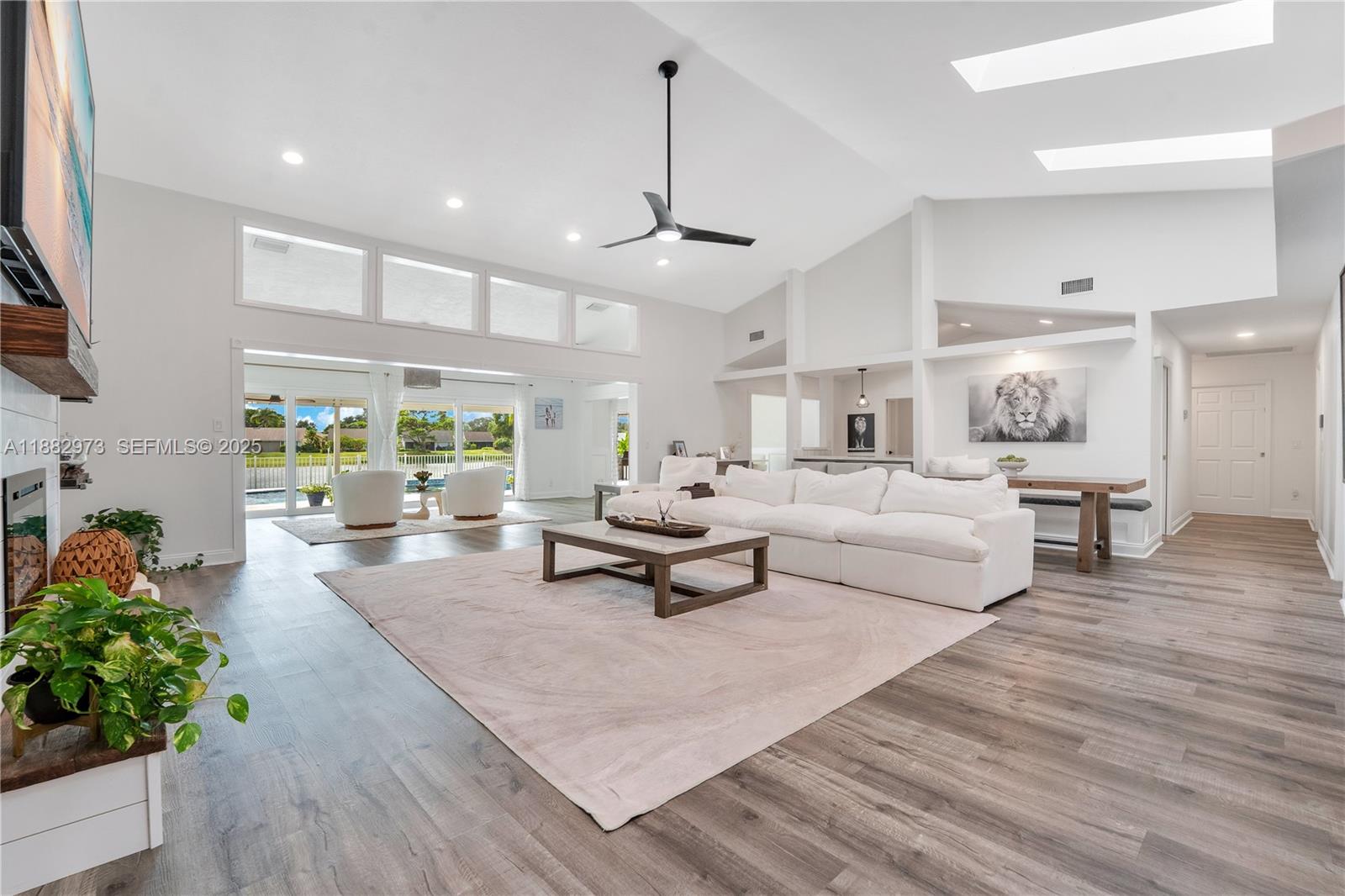 Golf membership is OPTIONAL! Turn-key 3/2 lakefront home+den (easily convertible to 4th bd) with oversized garage on quiet cul-de-sac. Open layout with lanai, new saltwater pool, lake & golf views. Enjoy skylights, the sunset, sunrise & lots of natural light. Beautifully resurfaced marble kitchen countertops for a refreshed, elegant finish. Renovated kitchen & master bath, new flooring, and fireplace with shiplap wall. Roof (2021), Trane AC (2021), ducts/insulation (2022), water heater (2022), impact sliders (2019), full interior/exterior paint (2024), putting green & outdoor kitchen w/ fridge, plus freshly painted driveway (2025). HOA: Community pool, spa/hot tub, tennis, pickleball, driving range, 18-hole golf course, & restaurant.5 miles to Jupiter Island beaches.