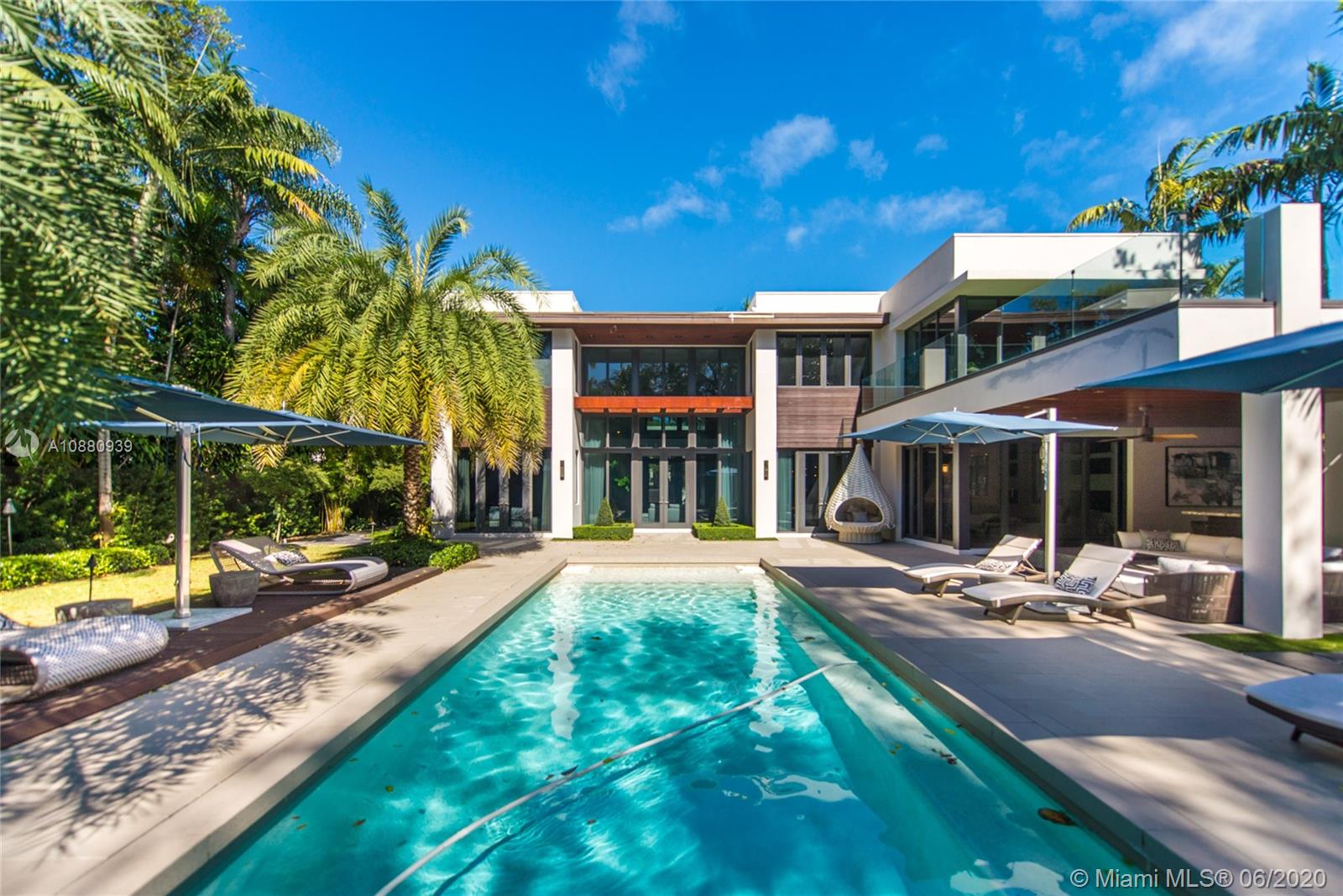 Located on exclusive Park Avenue in coveted Coconut Grove, this modern masterpiece is nestled on a lush, half-acre lot. Combining the finest elements of geometry, water, and light, this stylishly elegant home features 5 beds/6 baths over 7,200 SqFt of impeccable living area. Oversize floor to ceiling windows flood the home with sunlight and enhance the already dramatic entertaining areas. The Chef’s kitchen, large outdoor spaces, pool, putting green, basketball court and summer kitchen complete this perfect pairing of total luxury in an unparalleled setting.