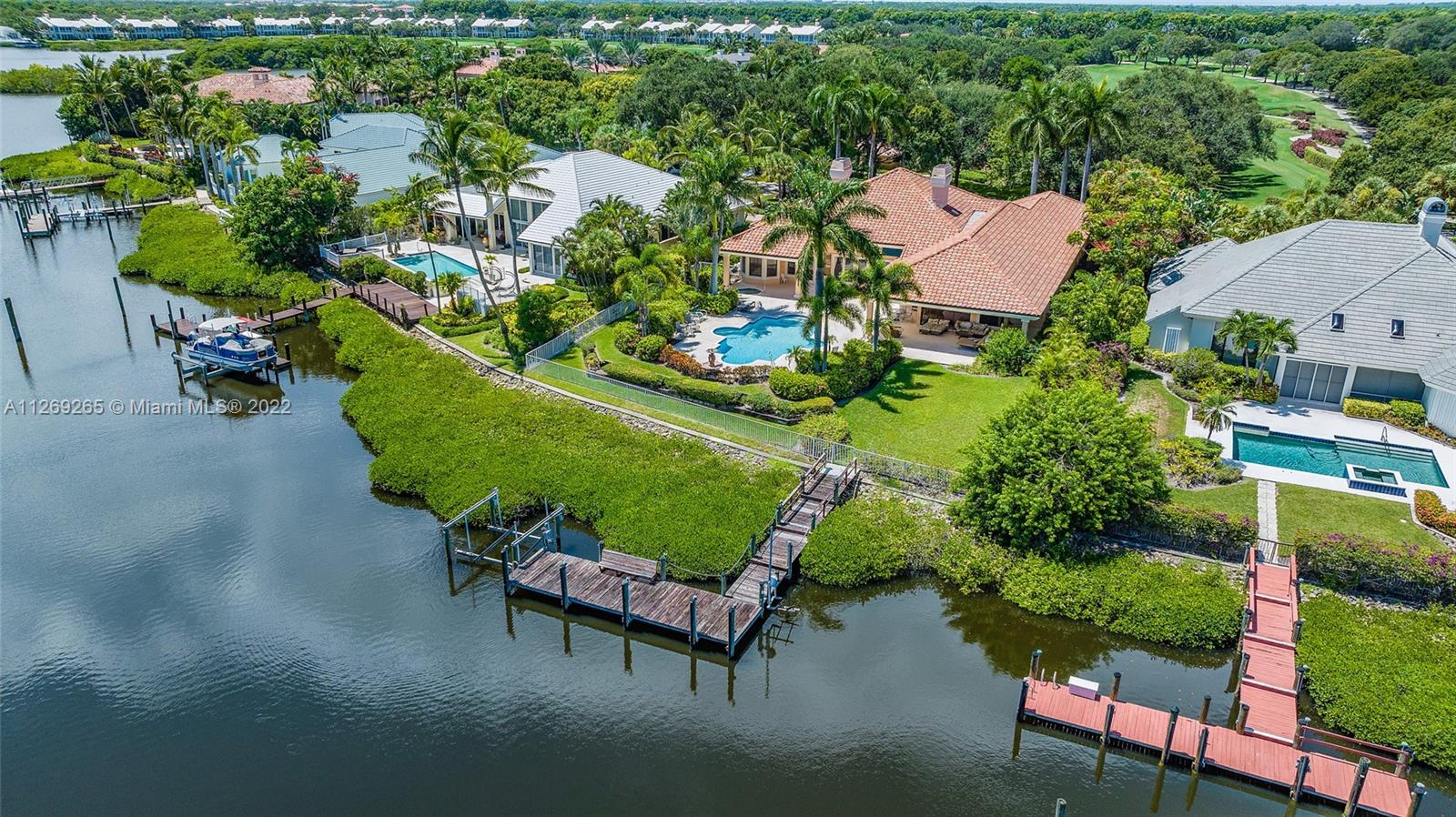 Custom Waterfront Estate Home with convenient location close to the main gate and clubhouse. If you like large, bright and sunny rooms then this property is the one for you. Lavish Owner's Retreat overlooking the waterway, with sitting room, 2 walk in closets, 2 baths, granite countertop, large tub and tons of storage. 2 oversized guest suites with private baths, large closets and are located off their own wing. Lush tropical landscaping surrounds the expansive backyard that provides beauty and privacy.
