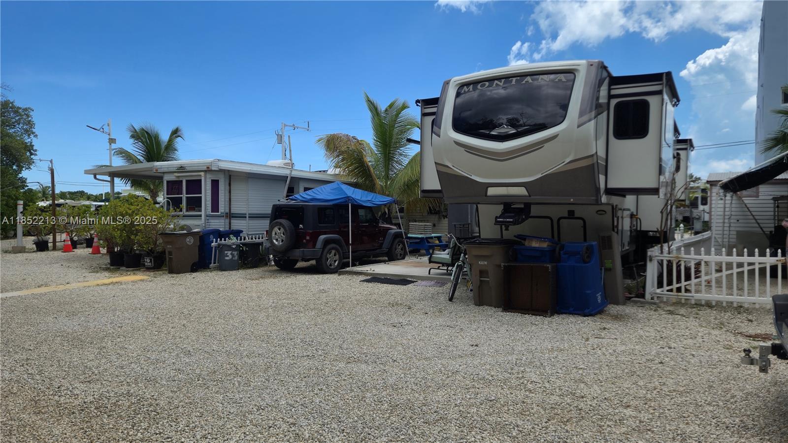 RV Paradise in Key Largo. Welcome to your slice of the Florida Keys—where laid-back luxury meets outdoor adventure. Nestled in a welcoming, family-oriented community, this private lot is RV-ready and features a shaded patio with awning for breezy island living. Just minutes from restaurants, shops, bait stores, and beaches—and a quick 45-minute drive to the mainland's airports, ports and malls. Enjoy amenities like a boat ramp, clubhouse, pool, tennis, and basketball courts. Lot has all utilities available, possible future rights to build your dream home in paradise. This property offers a one-day minimum rental. Daily, weekly, monthly or yearly rental allowed in the park.  Your keys escape is calling—come make it yours.