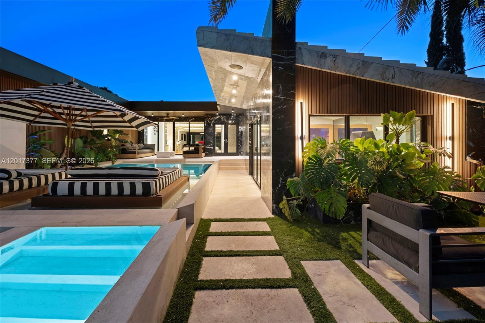Stunning topical modern home nestled away on private La Gorce Country Club. 5 Bedroom 4 Bath plus a powder room. Fully renovated smart home. With 2 Spacious principal suites with custom walk-in closets and bathrooms with double vanities and bathtubs, two guest suites with en-suite baths and the 5th bedroom is the gym/office. Features a european kitchen with Miele/Gaggenau appliances, a bar area ideal for entertaining, a fully cladded limestone pool with a gym/wellness area with Sauna, Steam, Cold Plunge and Jacuzzi. Live directly on the golf course in this private residence located moments away from world class dining, shopping, beaches and the Miami Beach lifestyle.
