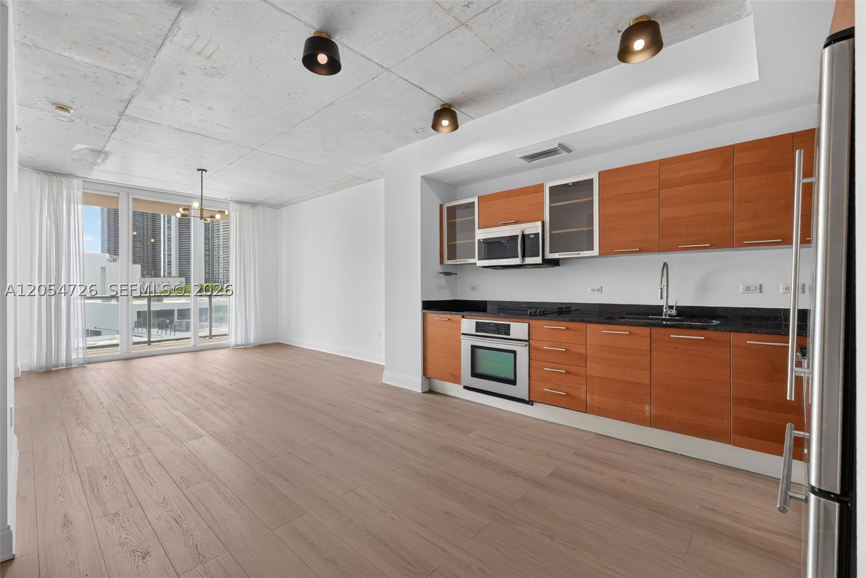This stunning 1 bed/1.5 bath at Two Midtown is move-in ready with brand new oak floors, an open-concept kitchen, and dramatic floor-to-ceiling impact windows. Unwind on your spacious private balcony after a day exploring the neighborhood. Bonus: 1 assigned parking space located on the same floor as your unit!Resort-style amenities include 24-hour security & concierge, sparkling pool, jacuzzi, sauna, kids' play area, and a fully equipped fitness center. Unbeatable location: walk to the Miami Design District, Wynwood Arts District, and some of Miami's trendiest restaurants & boutiques.