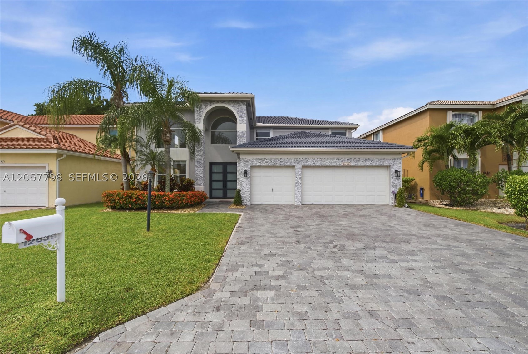 Welcome to this stunning modern 4-bedroom, 3.5-bathroom two-story residence in the desirable Bay Winds community of Boca Raton. Completely renovated with luxurious finishes and exceptional design, this home offers the perfect combination of elegance, comfort, and modern Florida living. The residence features impressive curb appeal with a stacked stone veneer façade, custom interlocking paver driveway, 3-car garage , and a beautiful double-door entry with frosted glass inserts. Inside, the open-concept floor plan showcases soaring double-height ceilings, high-gloss porcelain tile flooring, oversized impact windows, and abundant natural light throughout. The gourmet open kitchen is a true centerpiece, featuring elegant Calacatta quartz countertops, modern cabinetry, and a stylish layout perfect for entertaining. The private backyard oasis offers a resort-style swimming pool and built-in outdoor grill/summer kitchen, creating the ideal setting for gatherings and relaxation. Located in Bay Winds, a desirable Boca Raton community, residents enjoy a peaceful neighborhood atmosphere with convenient access to top-rated schools, shopping, dining, parks, and major roadways. This exceptional home combines luxury finishes, thoughtful renovations, and the ultimate indoor-outdoor lifestyle.