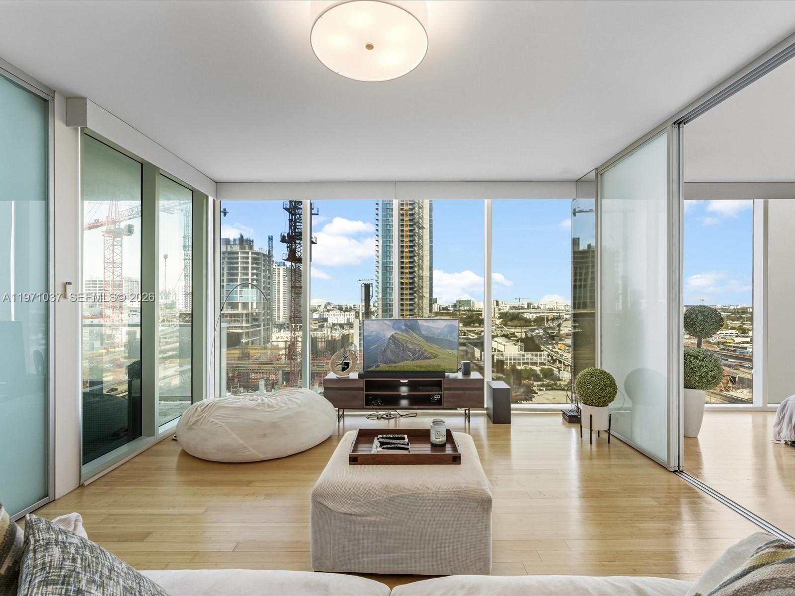 Live elevated at one of Miami’s most sought-after boutique luxury towers, Ten Museum Park, a landmark Downtown residence designed by award-winning architect Chad Oppenheim. A spacious 2-bedroom, 2-bath split floor plan showcasing breathtaking views of the Miami skyline through dramatic floor-to-ceiling impact glass. Perfectly positioned adjacent to and overlooking one of the world’s most iconic architectural masterpieces by Zaha Hadid — the stunning One Thousand Museum — this residence offers a rare front-row seat to globally celebrated design. The open-concept layout is ideal for entertaining, with a generous living area flowing seamlessly to a private balcony capturing sparkling city views. Sliding frosted glass doors provide privacy for both bedrooms while maintaining natural light throughout. The sleek kitchen is appointed with stainless steel appliances, top of the line cabinetry, and countertops, blending modern elegance with functionality. Located directly across from Museum Park and steps to the Pérez Art Museum Miami, Phillip and Patricia Frost Museum of Science, Kaseya Center, and Biscayne Bay residents enjoy unmatched walkability and cultural access. Five-star amenities include sunrise and sunset pools, resistance and cold plunge pools, jacuzzi, full-service spa, two fitness centers plus spin and yoga studio, 24-hour concierge, valet parking, and on-site management. Iconic architecture, resort-style amenities, and premier location define this exceptional offering.